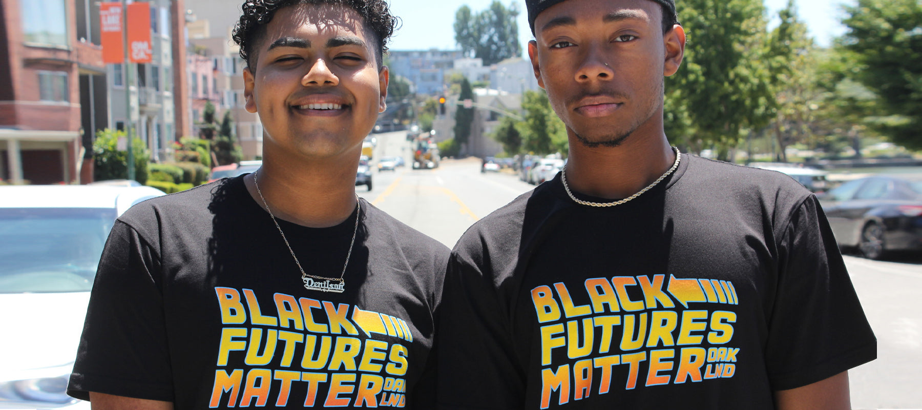 Two Men in Oakland Wearing black t-Shirts with “Black Futures Matter” graphic.