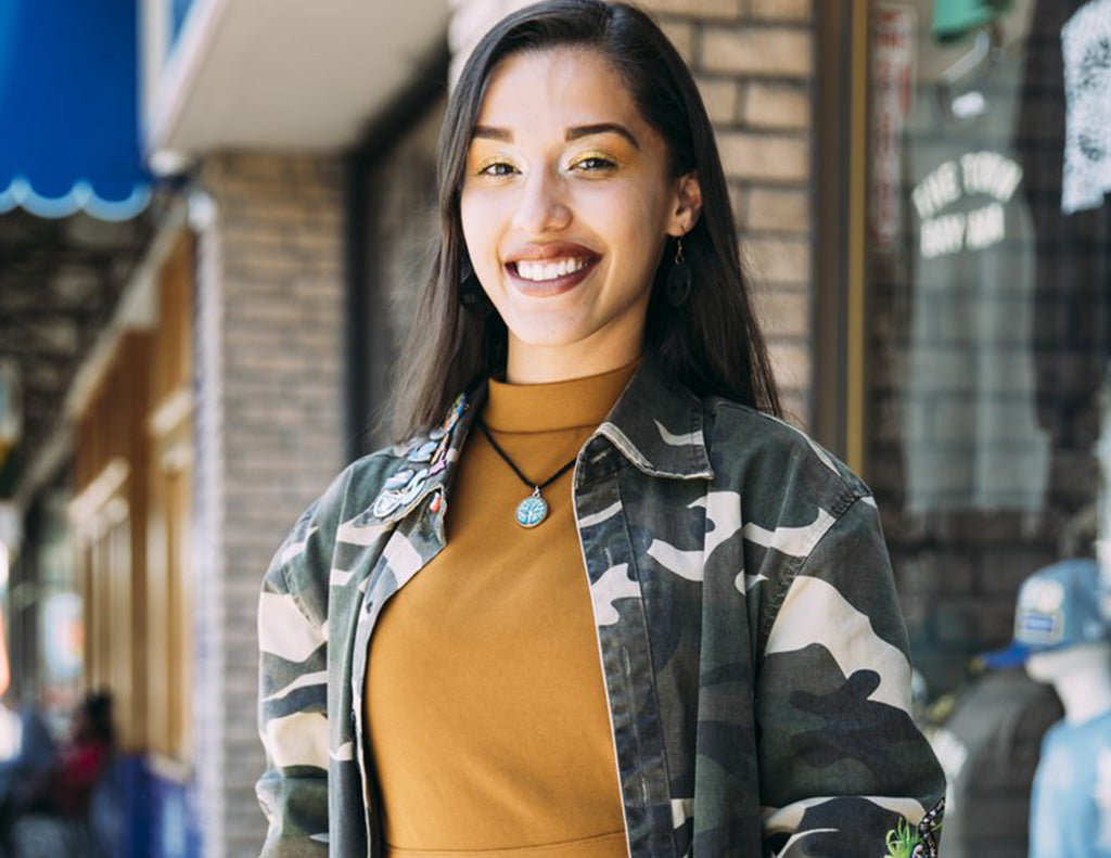 Anna standing smiling in front of the Oaklandish Dimond store.