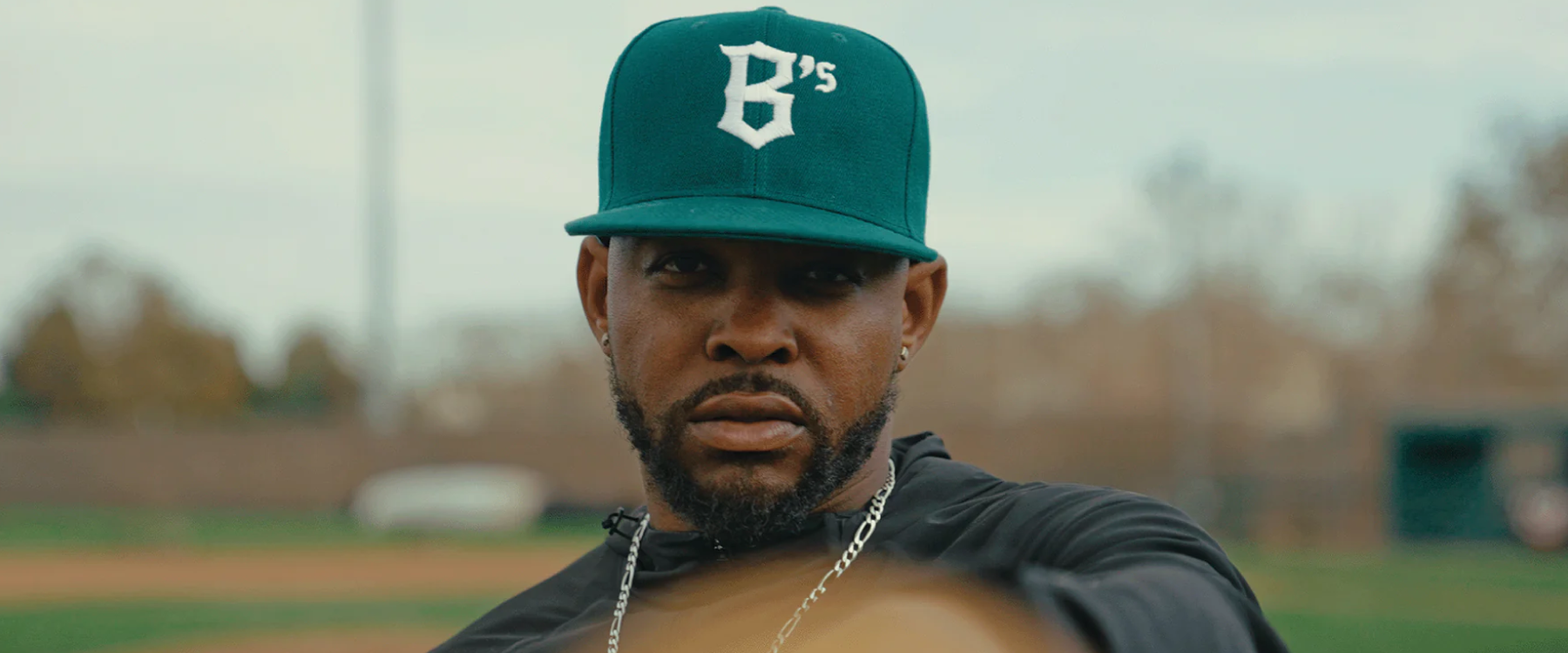 Image of man wearing a green Ballers baseball hat with B's logo.