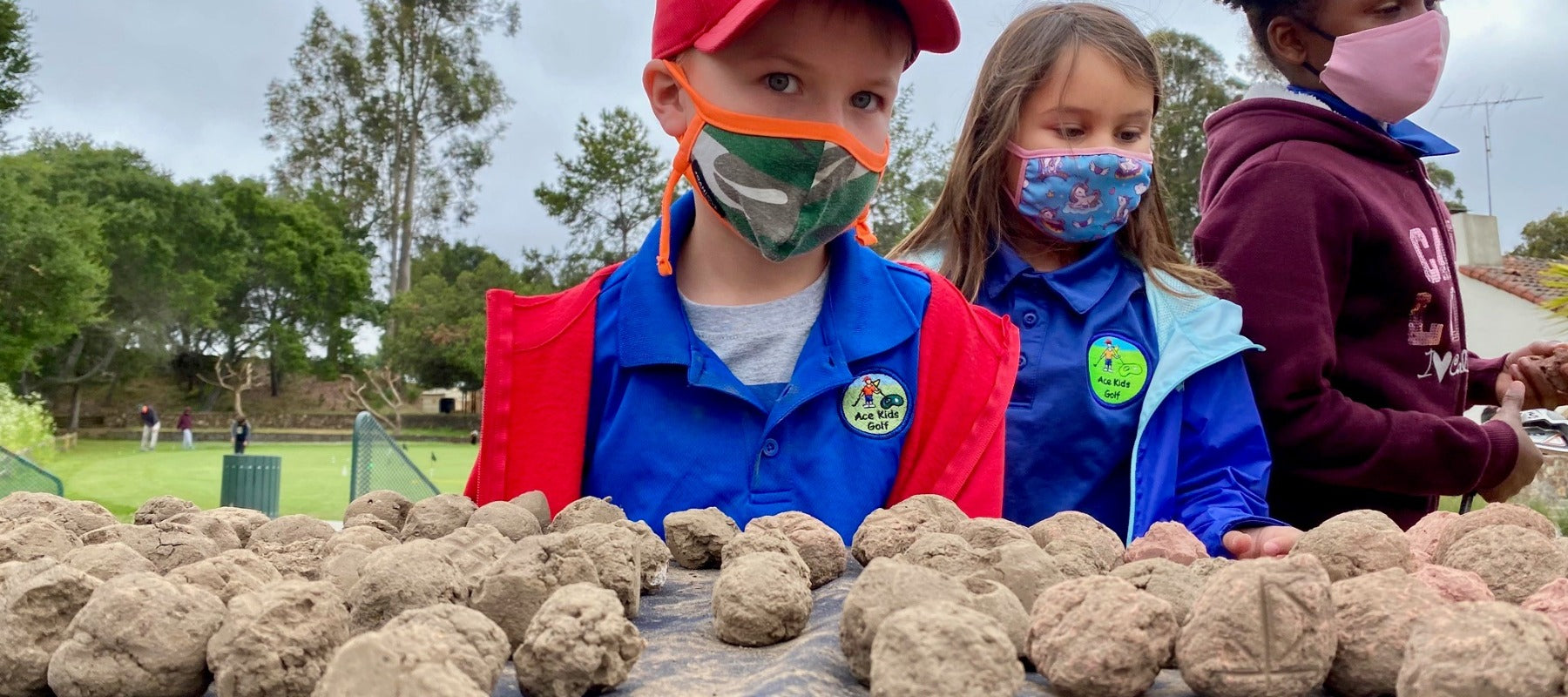 Two kids pollination seeds working with Pollinator Posse in Oakland