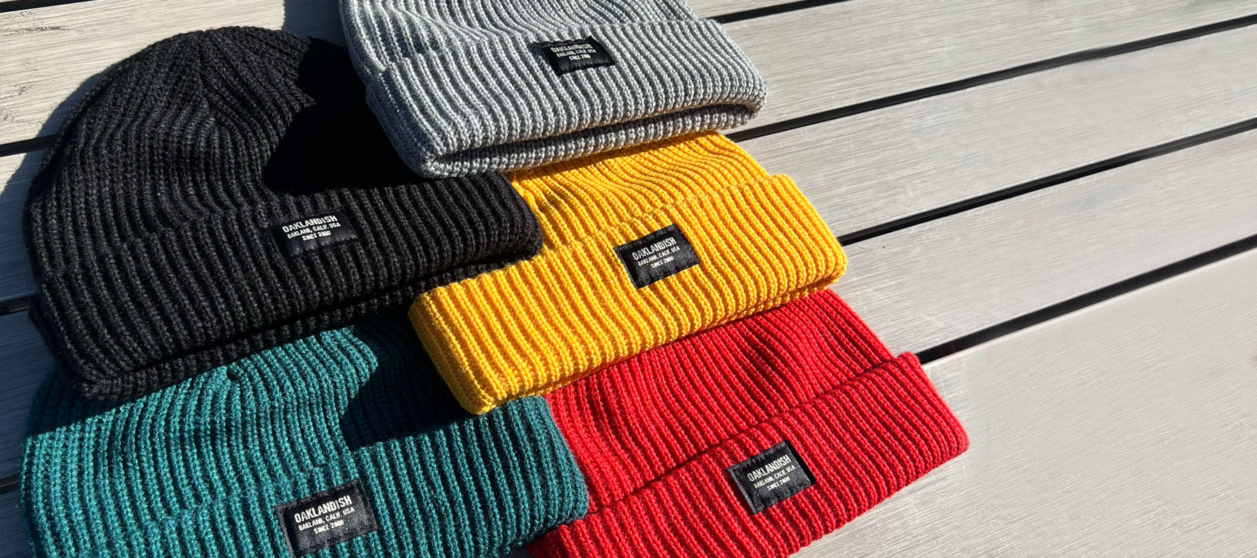 A collection of beanies with the Oaklandish and Hieroglyphics logo.