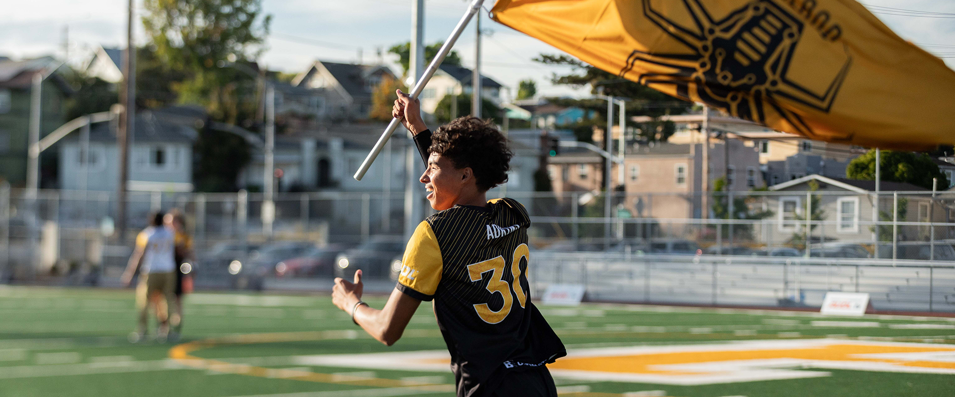 Oakland Spiders image of youth waving flag.