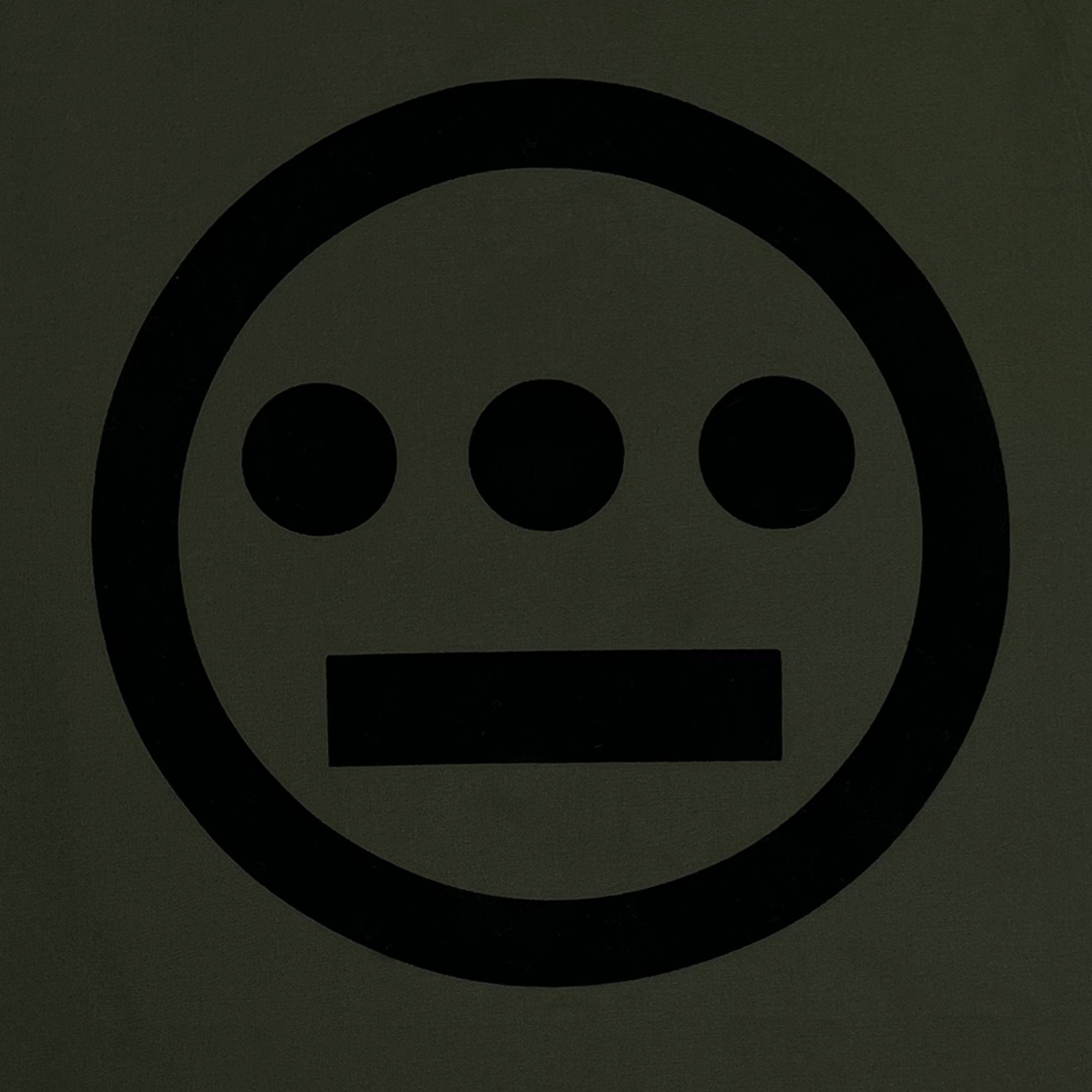 Close up of Hiero logo printed in black ink on backside of an Olive coaches jacket.