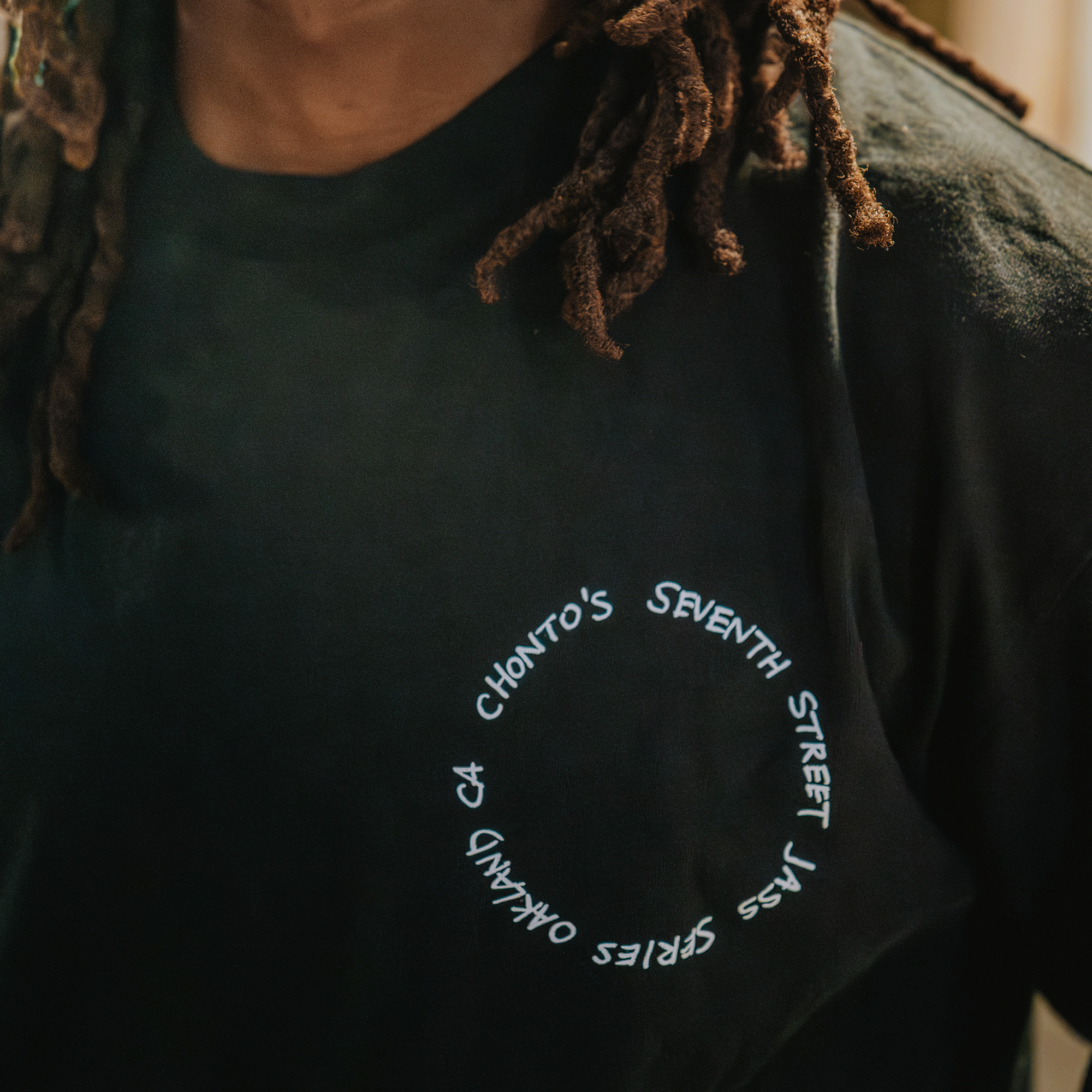 Person wearing a black t-shirt with white text design.