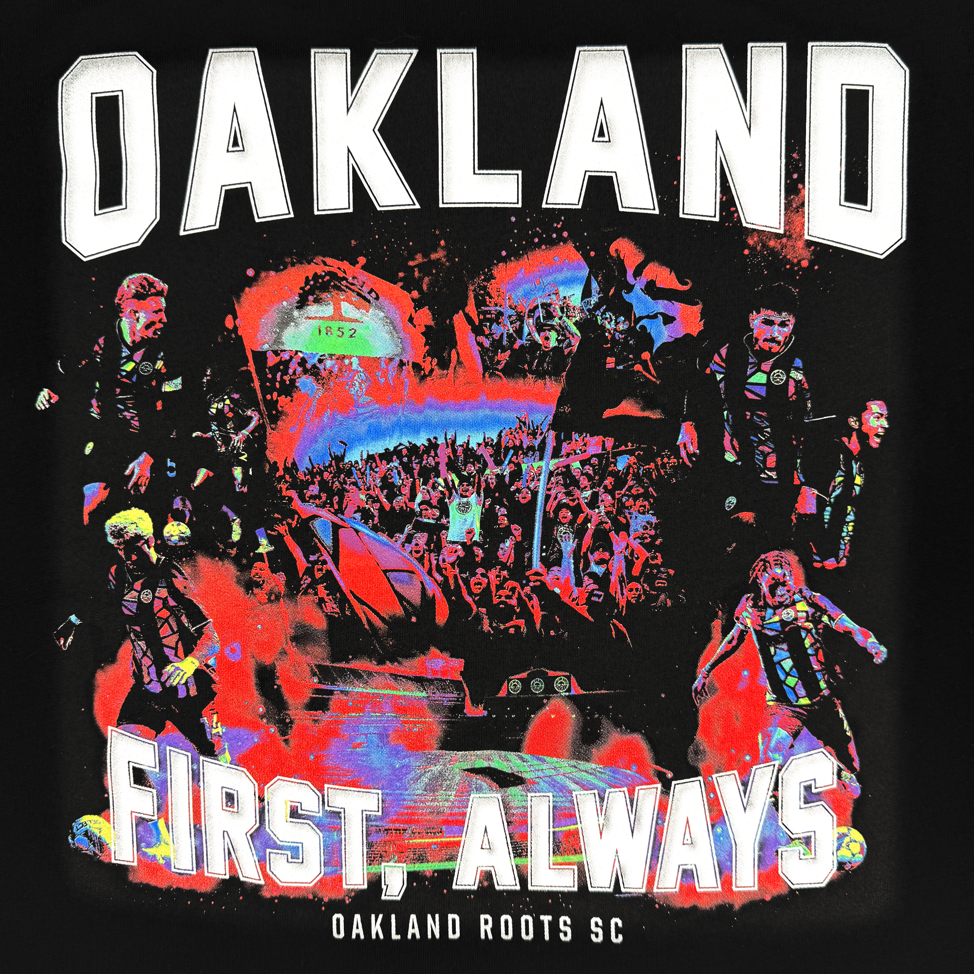 The OFA Tour Tee by Oakland Roots SC showcases collage-style artwork of soccer players and a lively crowd with vibrant colors. "OAKLAND" is prominently displayed at the top, followed by "FIRST, ALWAYS," featuring a helicopter and field, symbolizing the spirit and social commitment of the club.