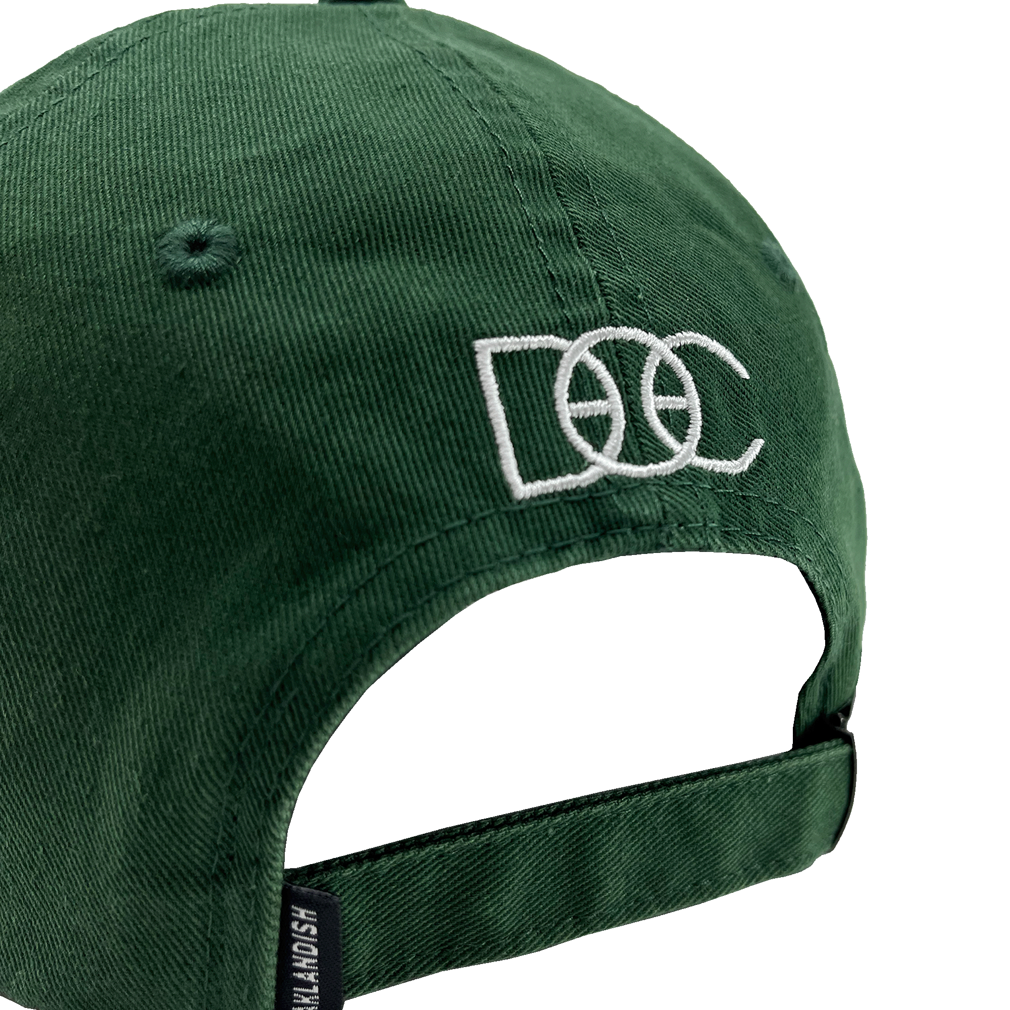 Angled back view of green Oakland Dad Hat designed by Dustin O. Canalin white embroidered DOC wordmark, adjustable strapback, and small Oaklandish wordmark tag.
