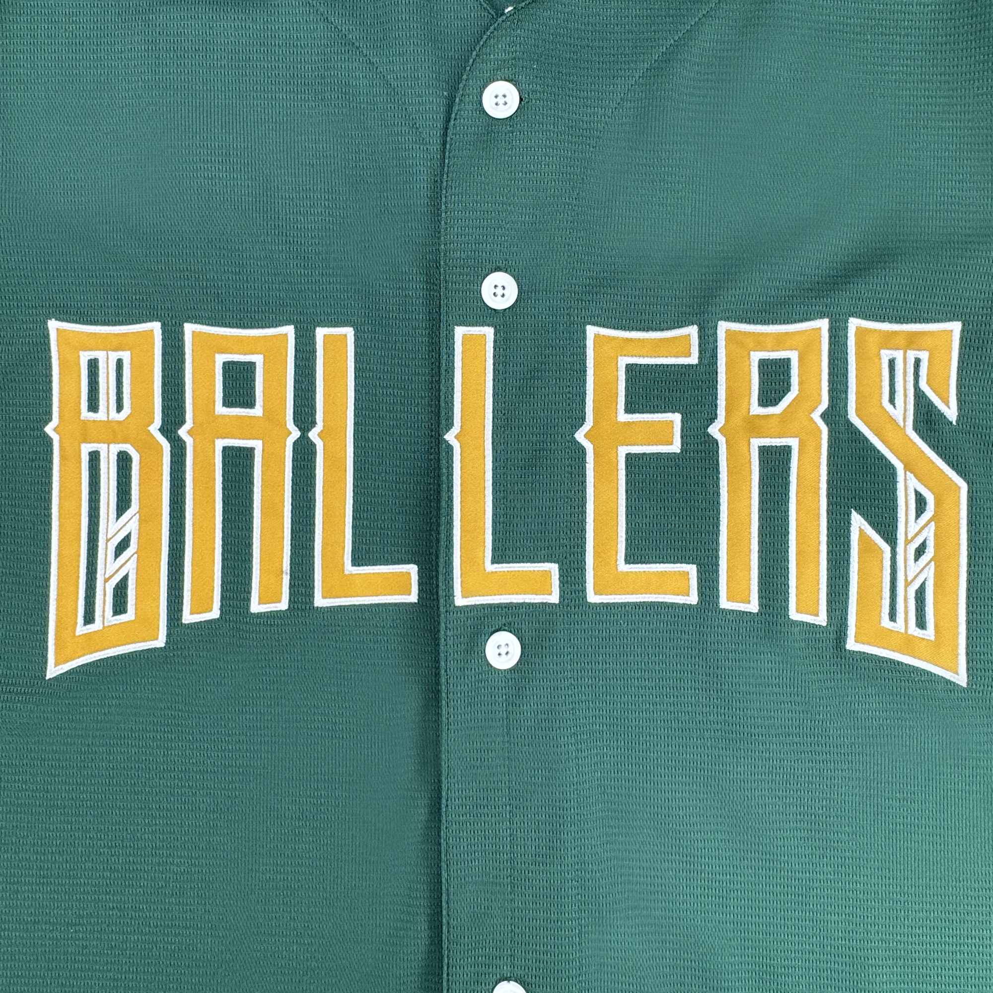 The Oakland Ballers Button Up Jersey by Oakland Ballers features green fabric, bold yellow and white "BALLERS" across the chest, angular lettering, and five white buttons for a classic Pioneer League team look.