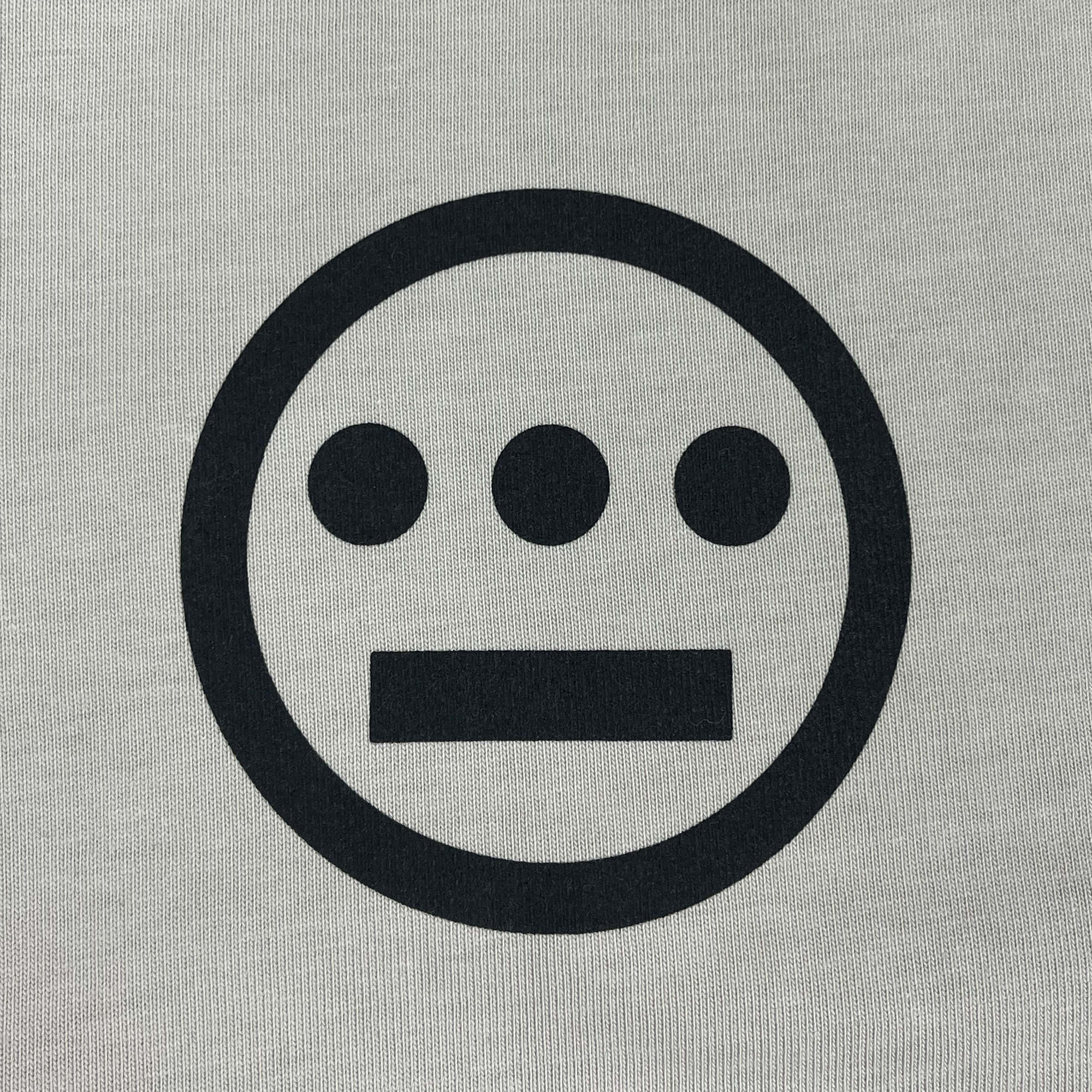Detailed close up of black Hieroglyphics Hip Hop logo on a bone-colored button-up baseball jersey.