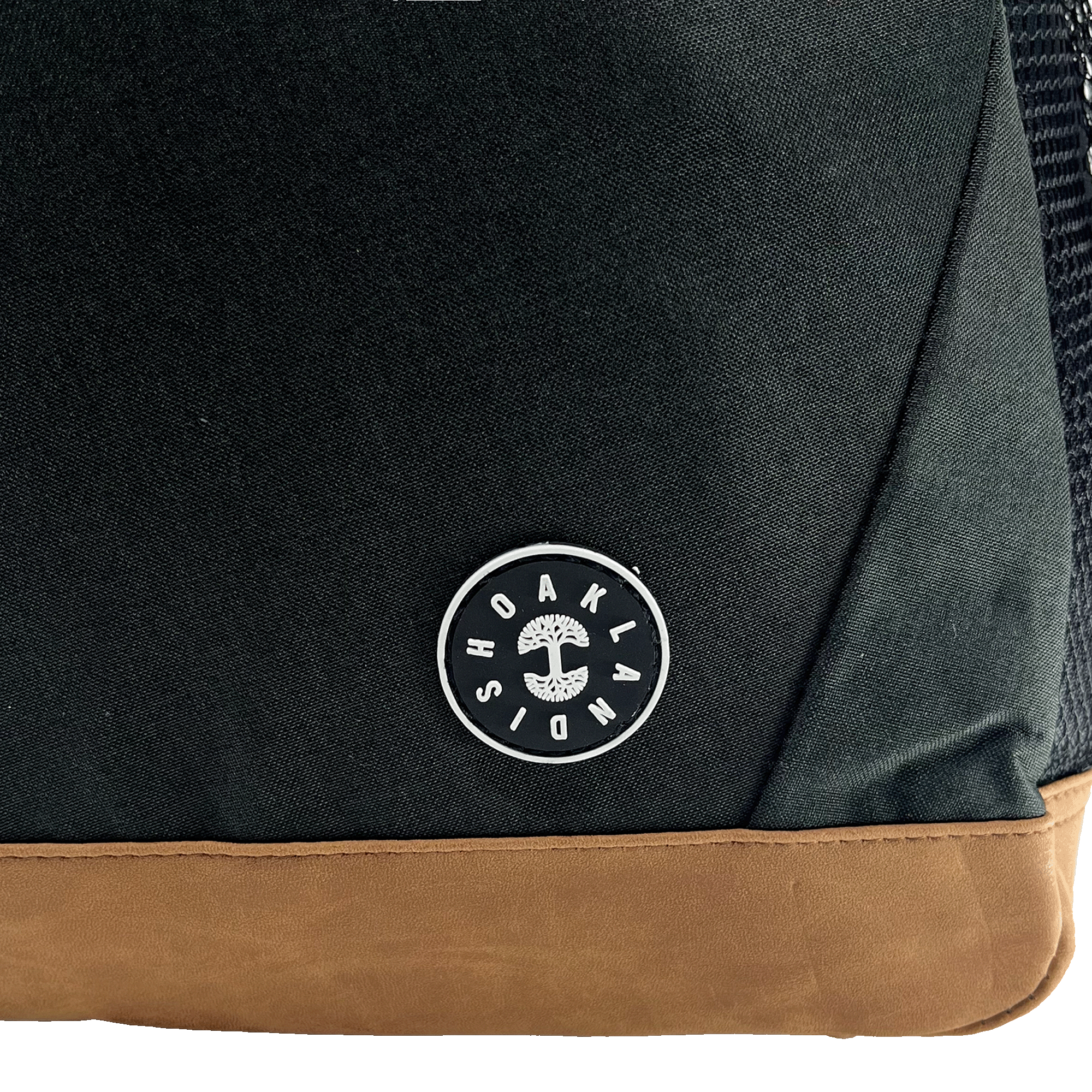 Close-up of Oaklandish tree logo and wordmark patch on a black backpack.