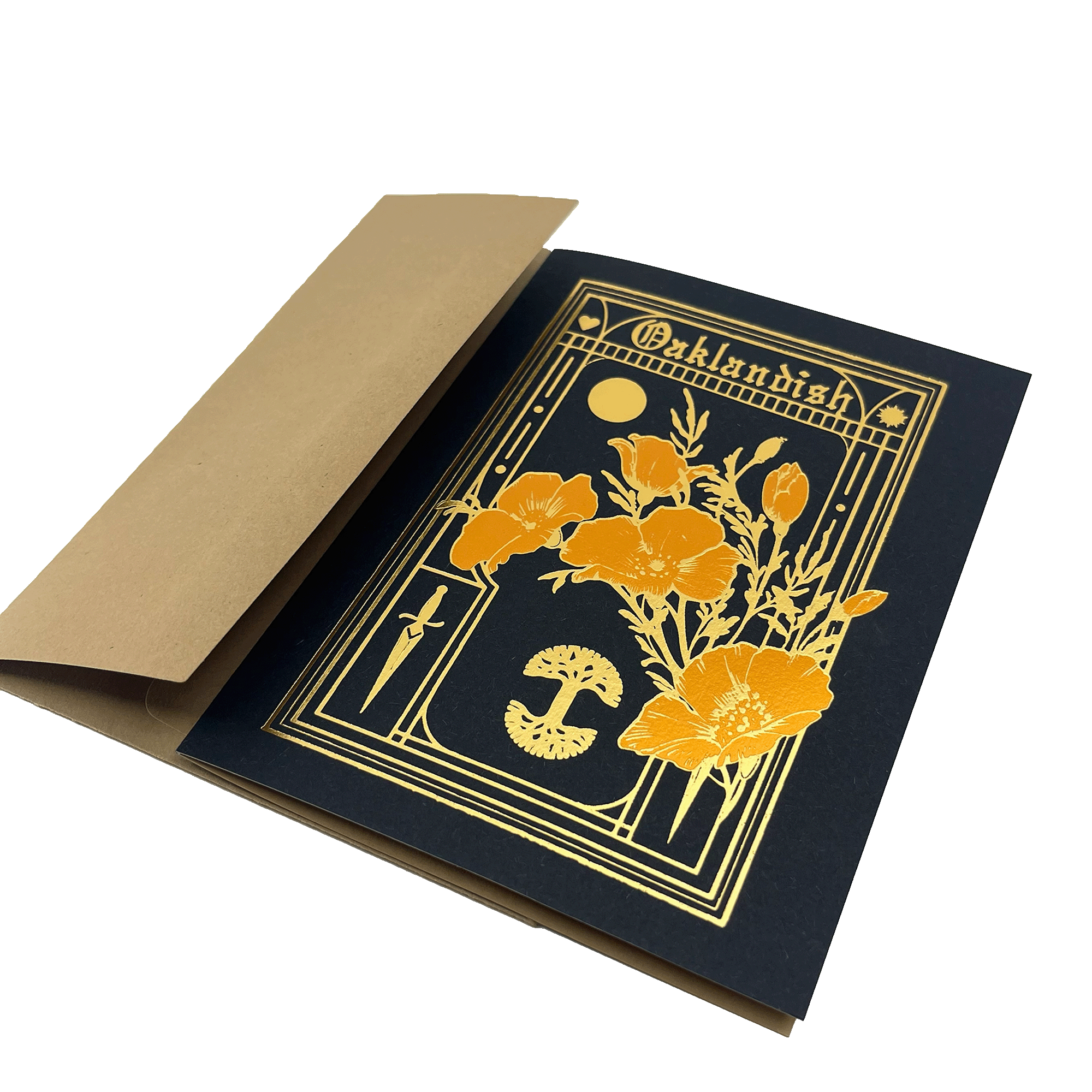 A rectangular Blossom Card by Never Elsewhere features a black background adorned with a gold foil floral design showcasing large poppy flowers and a mushroom. "Oaklandish" is printed in letterpress above the design. The card is partially inserted into a slightly open tan envelope made of recycled kraft paper.