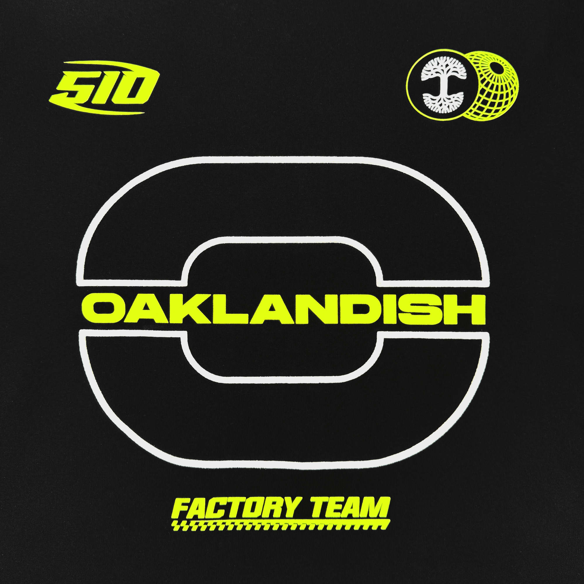 The Brrraaap Moto LS Tee by Oaklandish is a black men’s shirt with a bold white “O” outline, “OAKLANDISH” in yellow block letters inside, yellow and white logos above, and “FACTORY TEAM” in yellow italics with a dashed underline below.