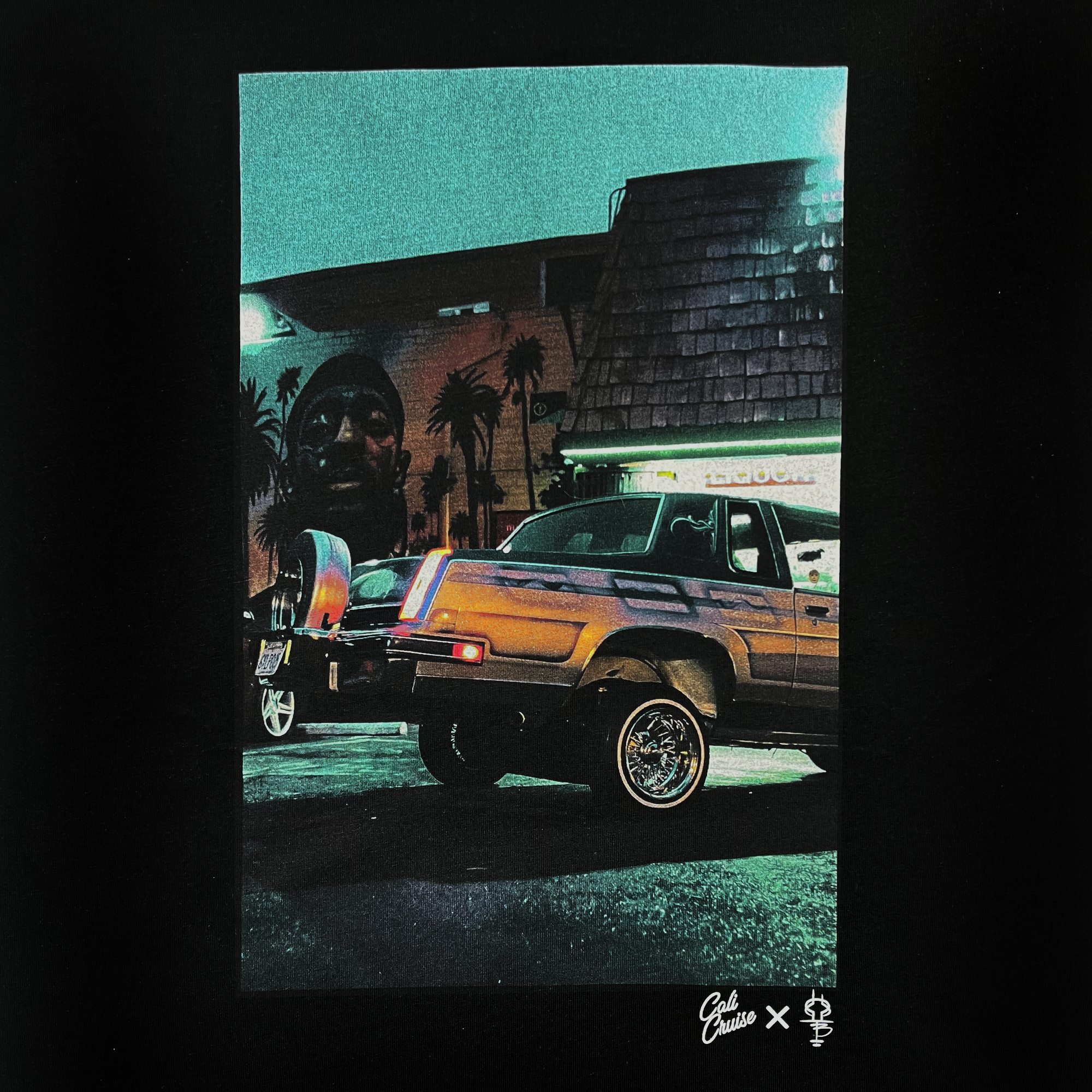 Close-up of an image of Armando’s lowrider car parked in front of a Nipsey Hussle mural on a black t-shirt.