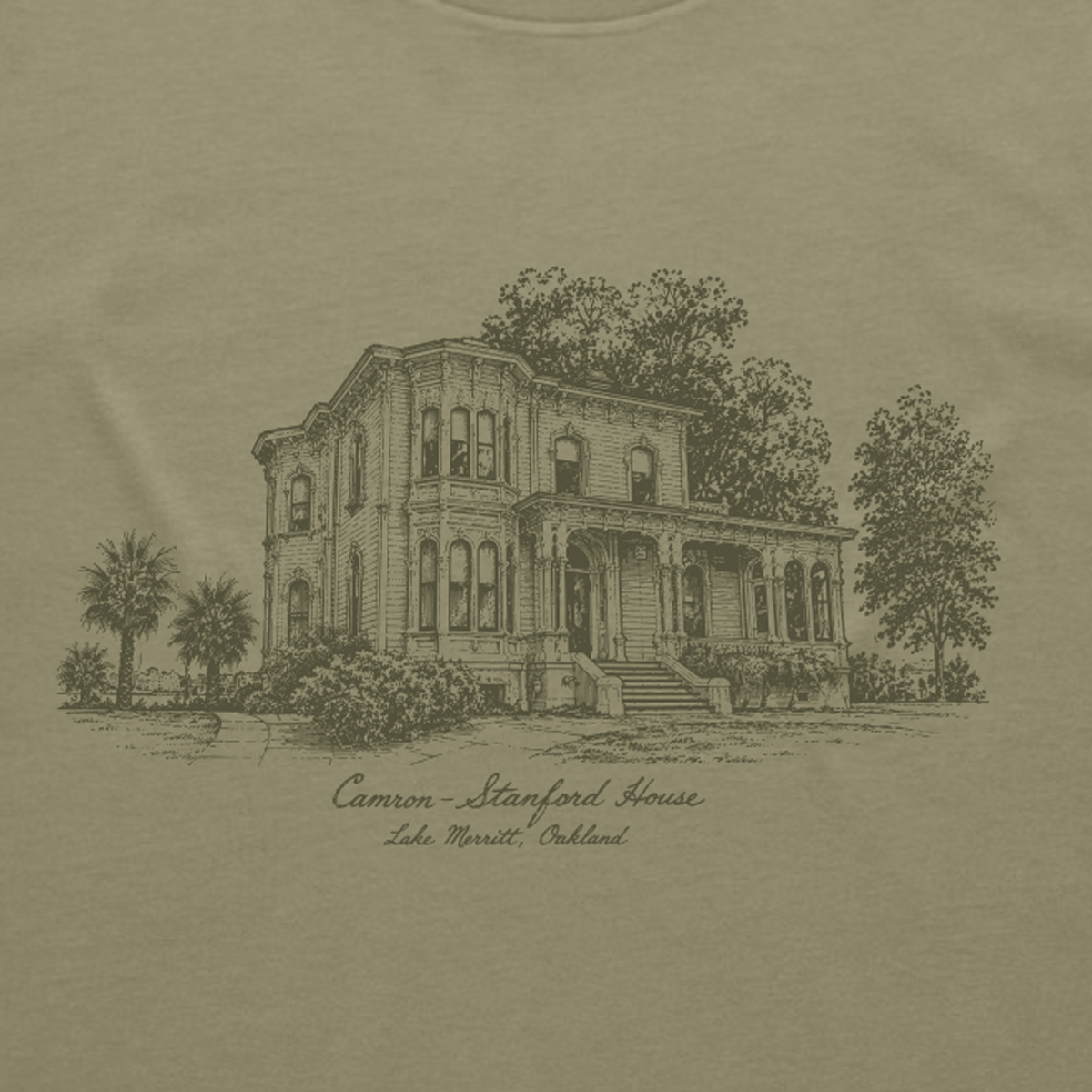 A detailed black line drawing of a large Victorian estate with a porch, surrounded by trees, stands out on a tan background of the Oaklandish Camron Stanford Tee. Below the illustration, cursive lettering reads: “Camron-Stanford House, Lake Merritt, Oakland.”.