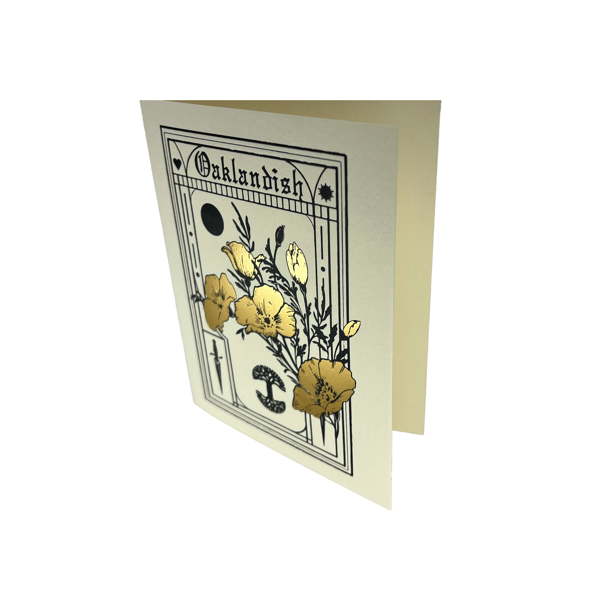 The Blossom Card by Never Elsewhere stands partially open, showcasing a vintage botanical design. The cover features yellow flowers highlighted with metallic gold foil, framed by a black border and decorative details. The word "Oaklandish" is prominently displayed at the top, accompanied by celestial symbols like a crescent moon. It includes a recycled brown kraft paper envelope.