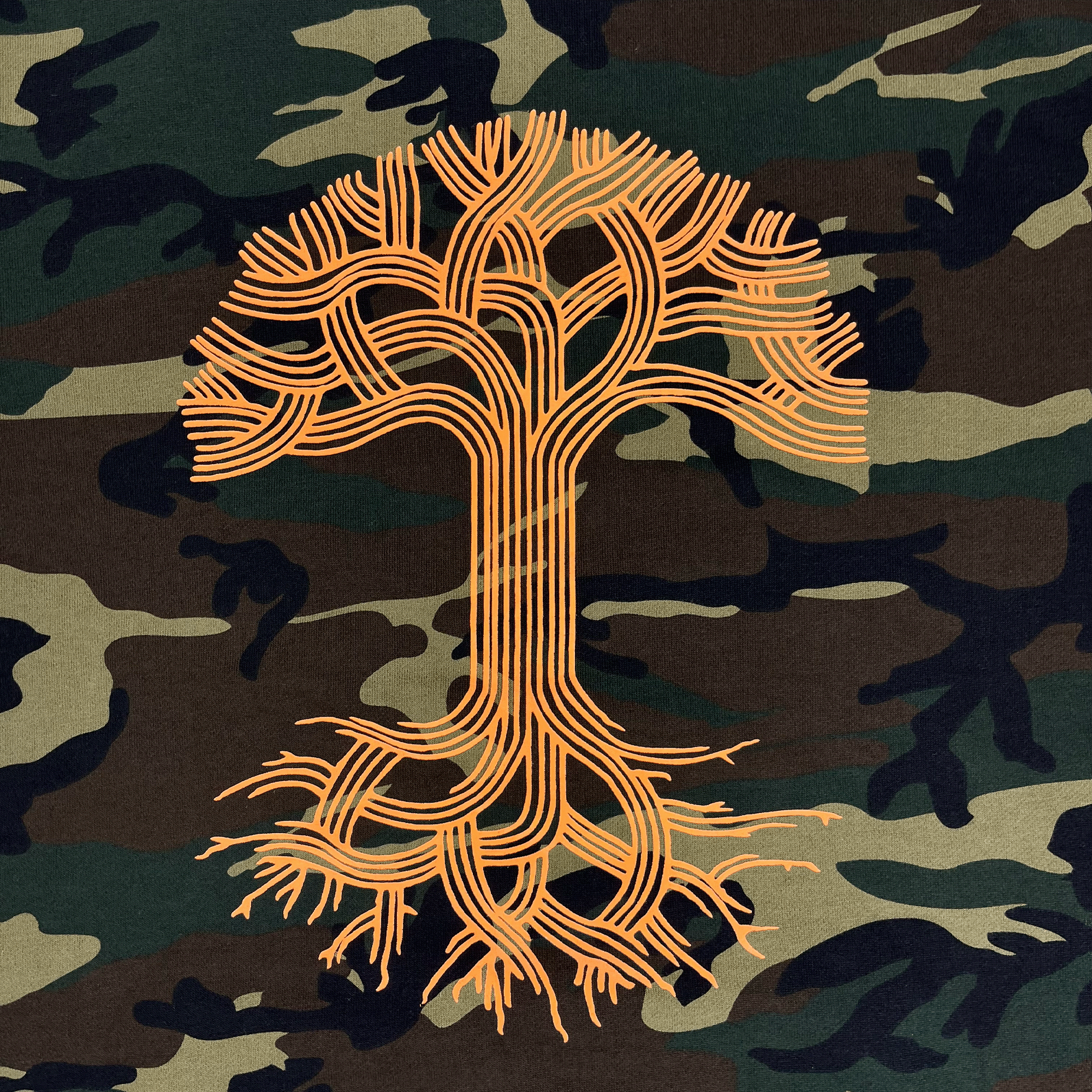 Close-up of a large orange Oaklandish tree logo in the center of a camo hoodie.