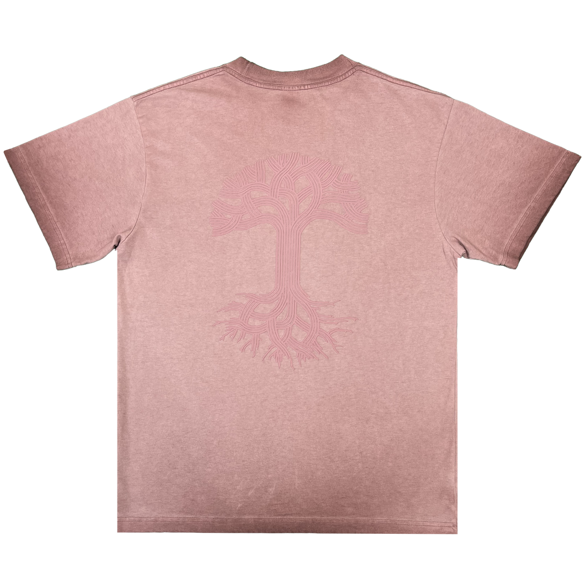 The Oaklandish Classic Logo Tee by Oaklandish is shown laid flat in a faded mauve heavyweight cotton. The back displays a subtle, line-art rendition of the brand’s iconic tree logo—with branching roots and branches—printed in a slightly darker pink. This classic fit t-shirt features short sleeves and a minimalist design with no additional visible details.