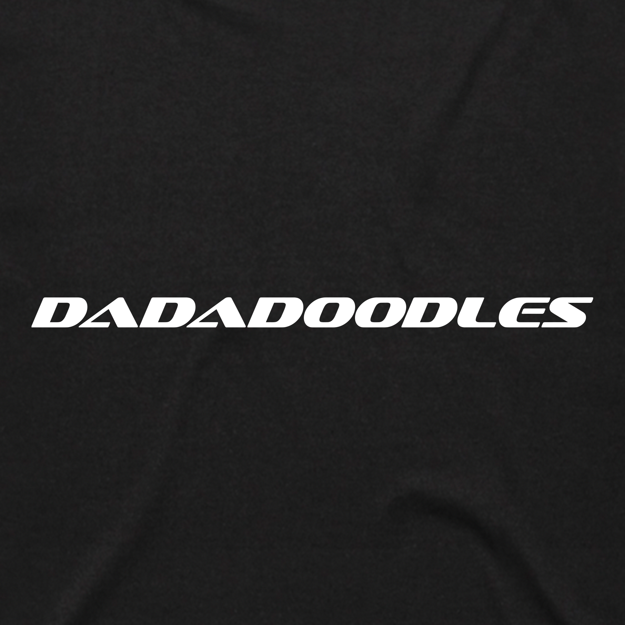 White bold text reading "DADADOODLES" in an italic, modern font is centered on a solid black background with subtle fabric texture and faint folds, evoking the sporty vibe of the Oaklandish Hammer into Time Tee.