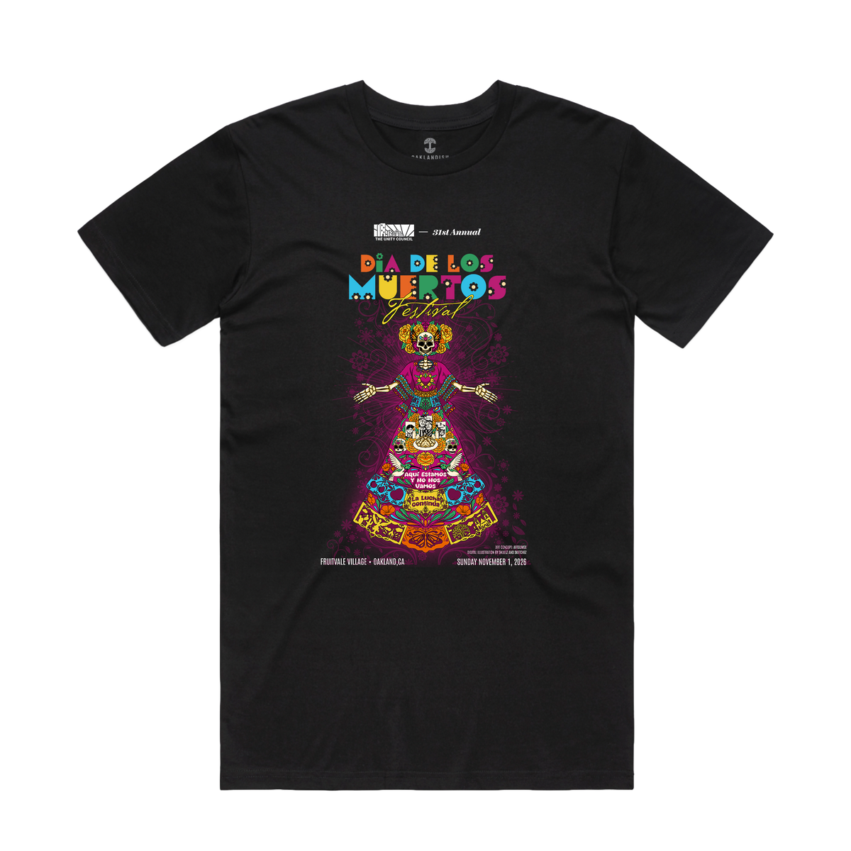 The Oaklandish La Catrina de Oakland Tee is a black crew-neck t-shirt featuring a central graphic of a La Catrina figure surrounded by vibrant marigolds, skulls, and sugar skull motifs, with text detailing a festival at Fruitvale Transit Village.