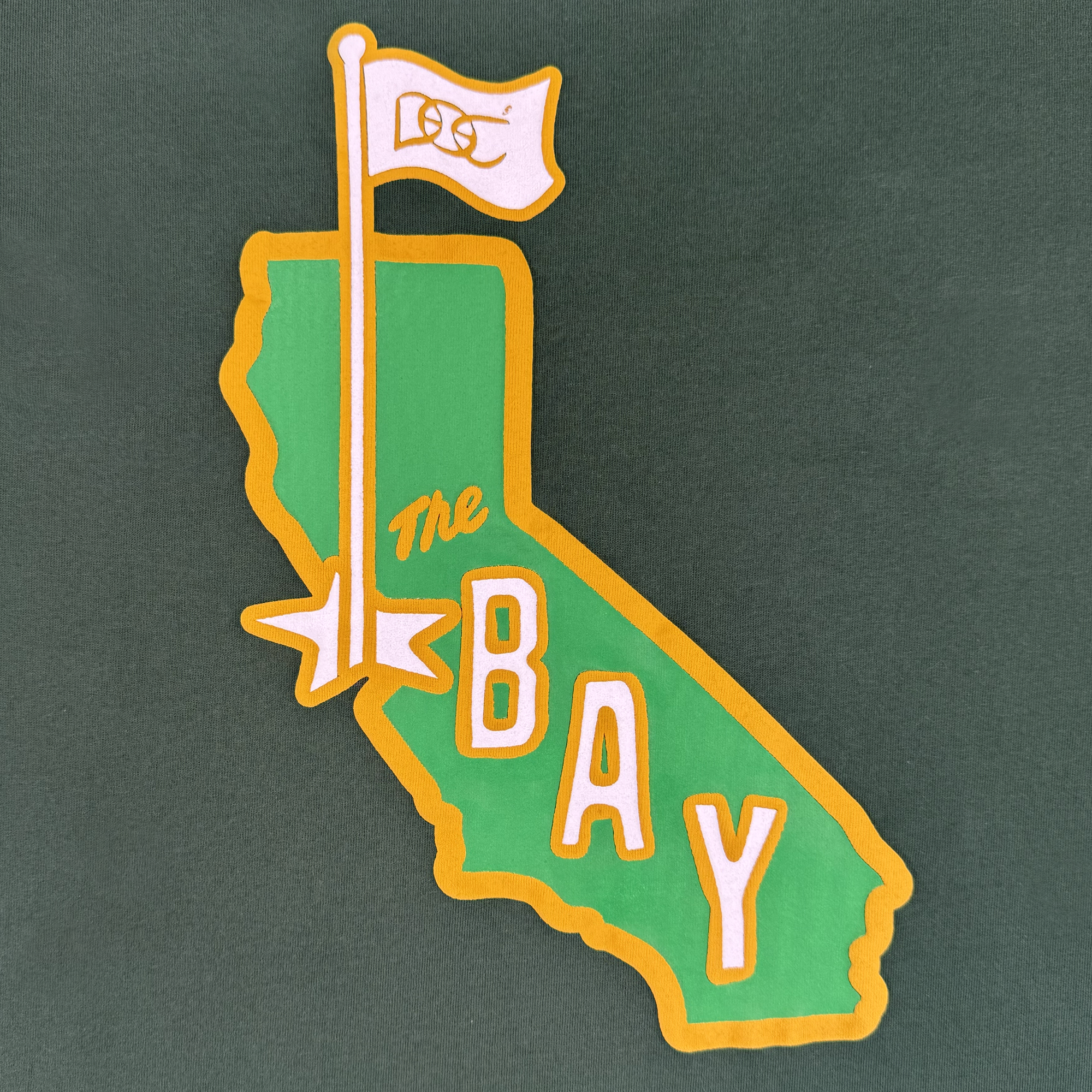The CA Bay Area Tee By DOC by Oaklandish features California’s outline in green with a yellow border, “The BAY” lettering, and is part of The Bay Collection. This classic-fit shirt is made from heavyweight cotton for lasting comfort.