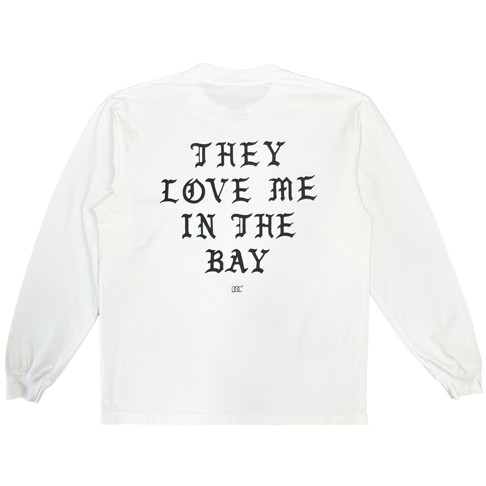A heavyweight cotton long sleeve t-shirt, the They Love Me LS Tee By Doc from By DOC features a white base with bold black Gothic text reading “THEY LOVE ME IN THE BAY” across the back and a small logo underneath. Designed in men’s sizing, this shirt includes ribbed cuffs and a classic crew neckline.