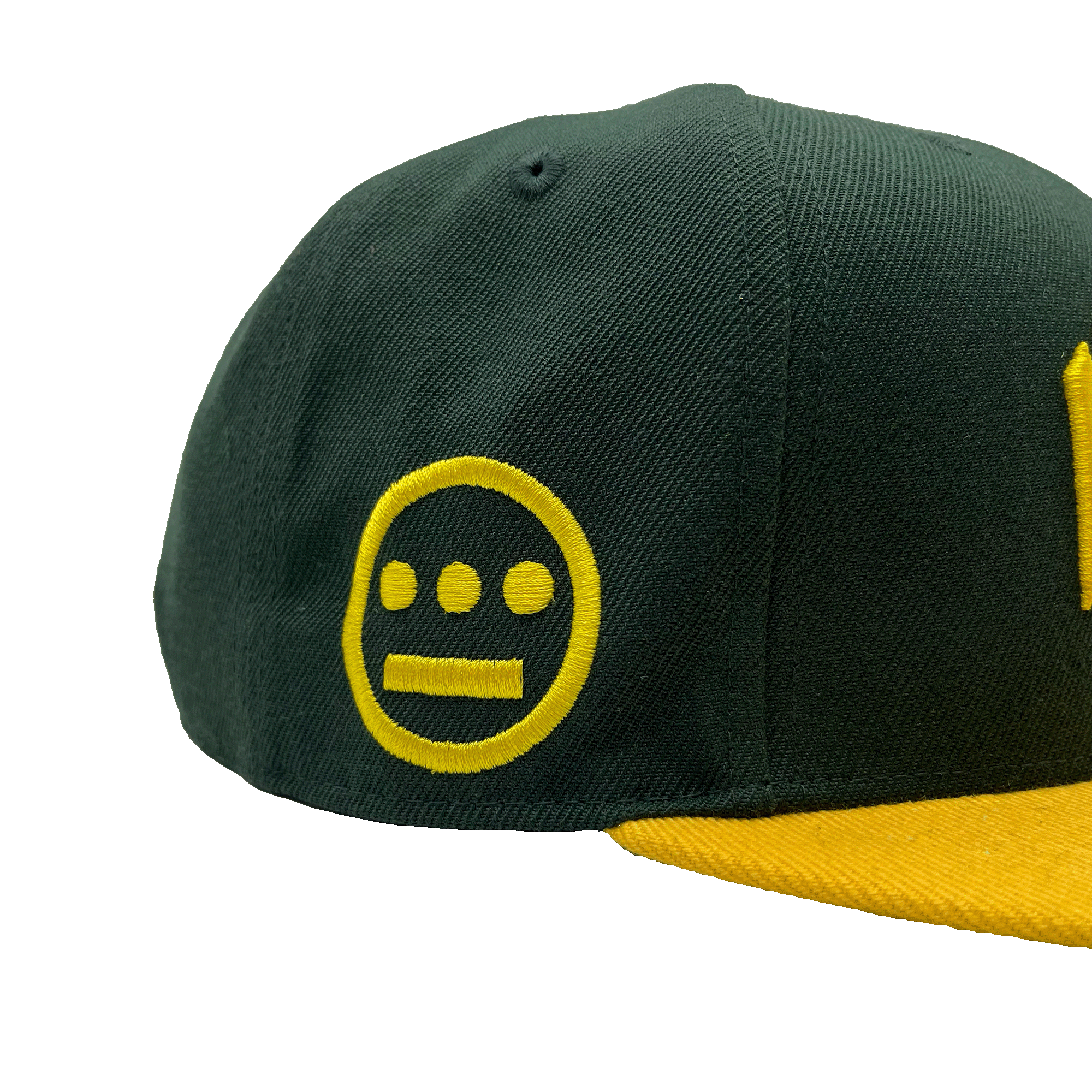 Side view of HIERO logo on the side of a green snapback cap with yellow flat billed visor.