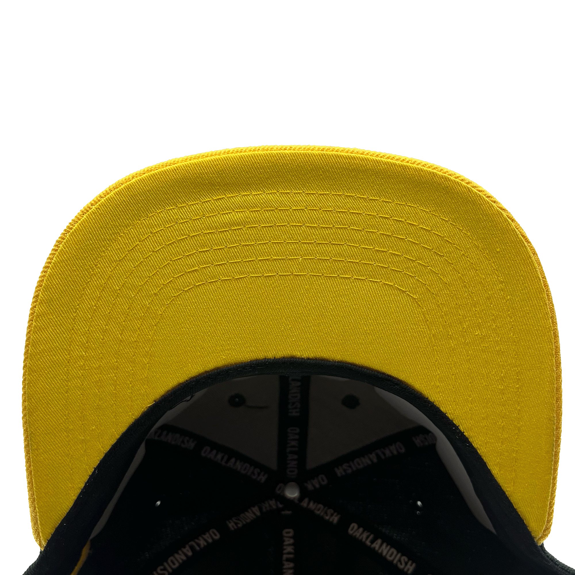 Underside view of flat yellow bill with OAKLANDISH wordmark taping inside.