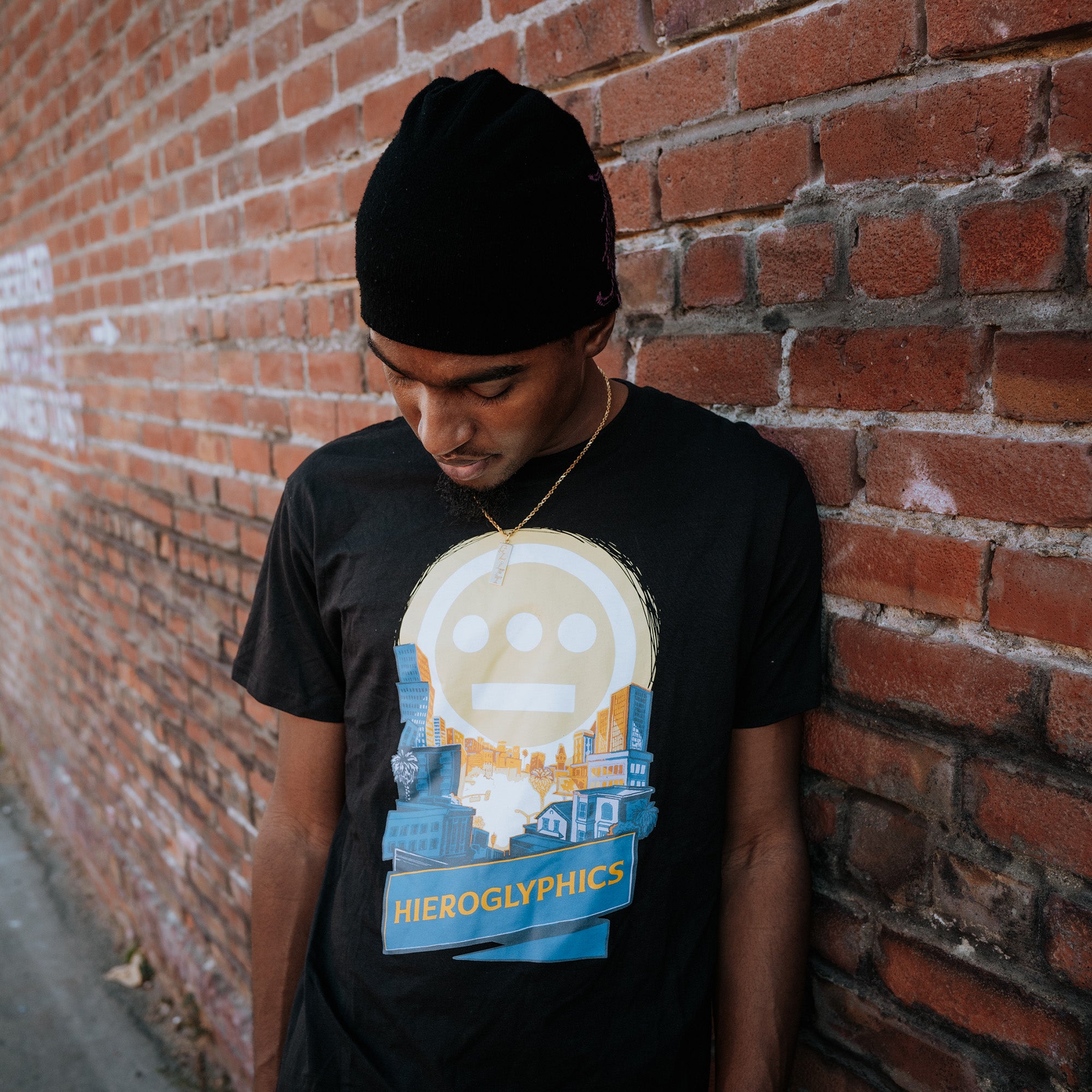 Model wearing a black t-shirt with Hiero Valley, Hieroglyphics Hip Hop Graphic on the front chest.