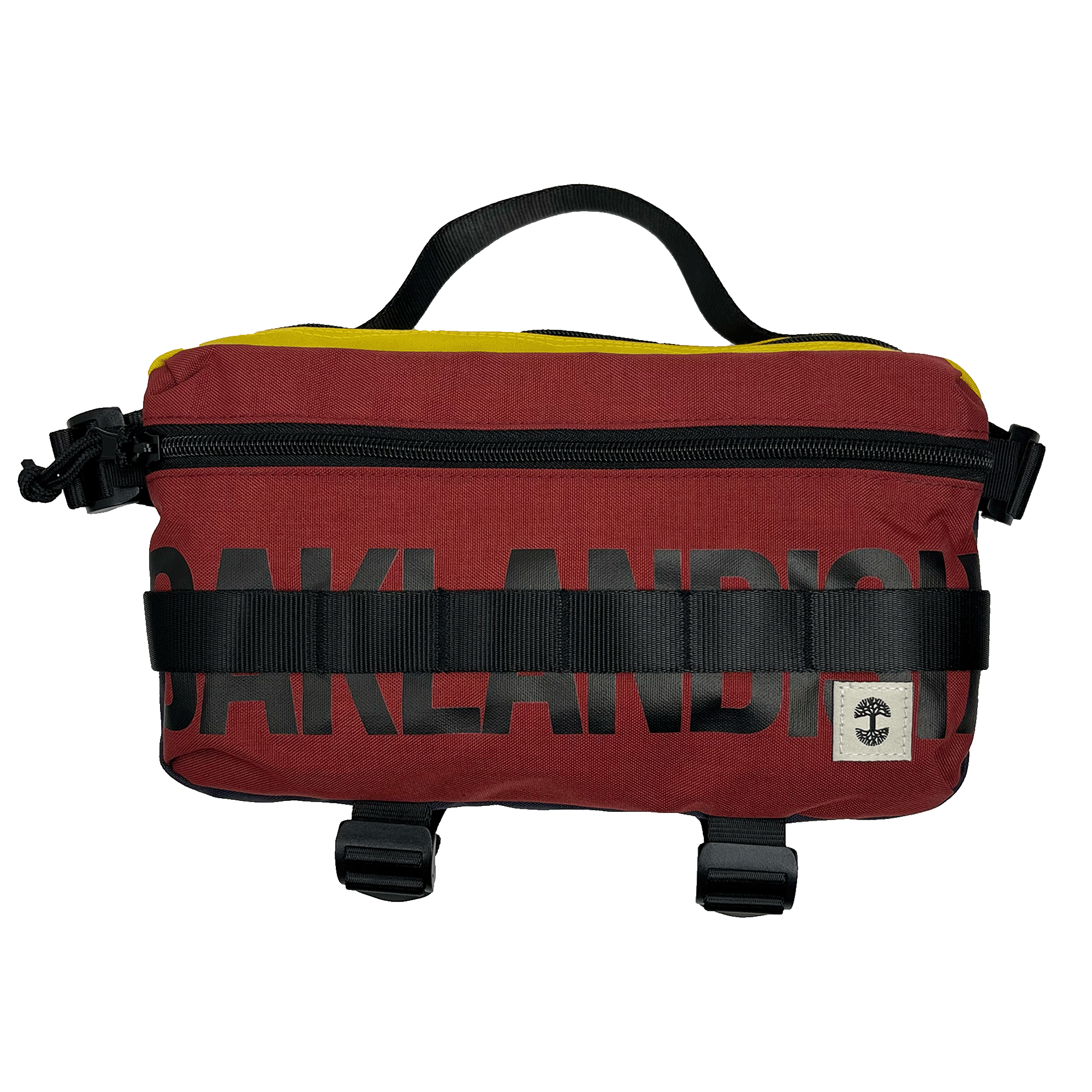 The Oaklandish Hip Bag is a rectangular, maroon waist bag featuring black zipper and buckle details for a premium look. The word "OAKLANDISH" is prominently displayed in black block letters across the front. A small white label with a black tree logo decorates the lower right corner, and a black handle on top adds to its unisex appeal.