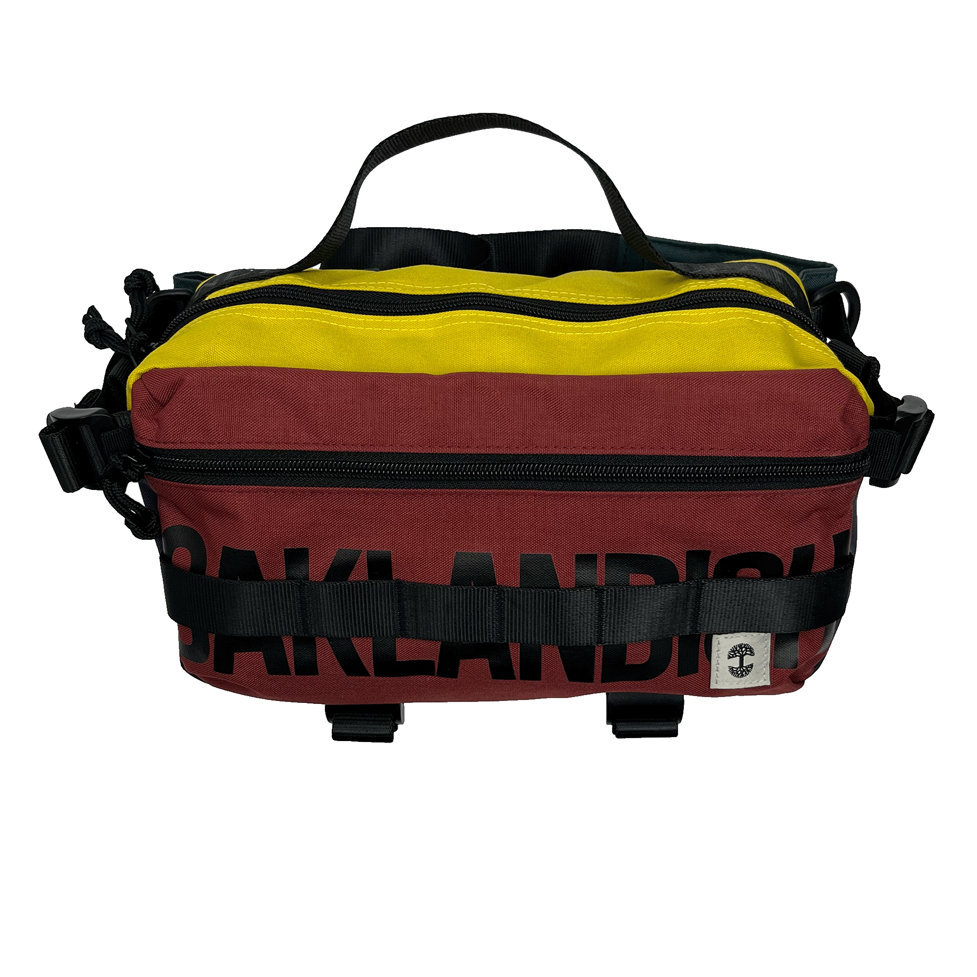 The Oaklandish Hip Bag by Oaklandish is a small, colorful cross-body bag showcasing horizontal stripes in yellow, maroon, and black. The word "Oaklandish" is partially visible in large black letters on the maroon section. It features black zippers and adjustable straps for a versatile unisex appeal and is adorned with a premium white-and-black logo patch on the bottom right.