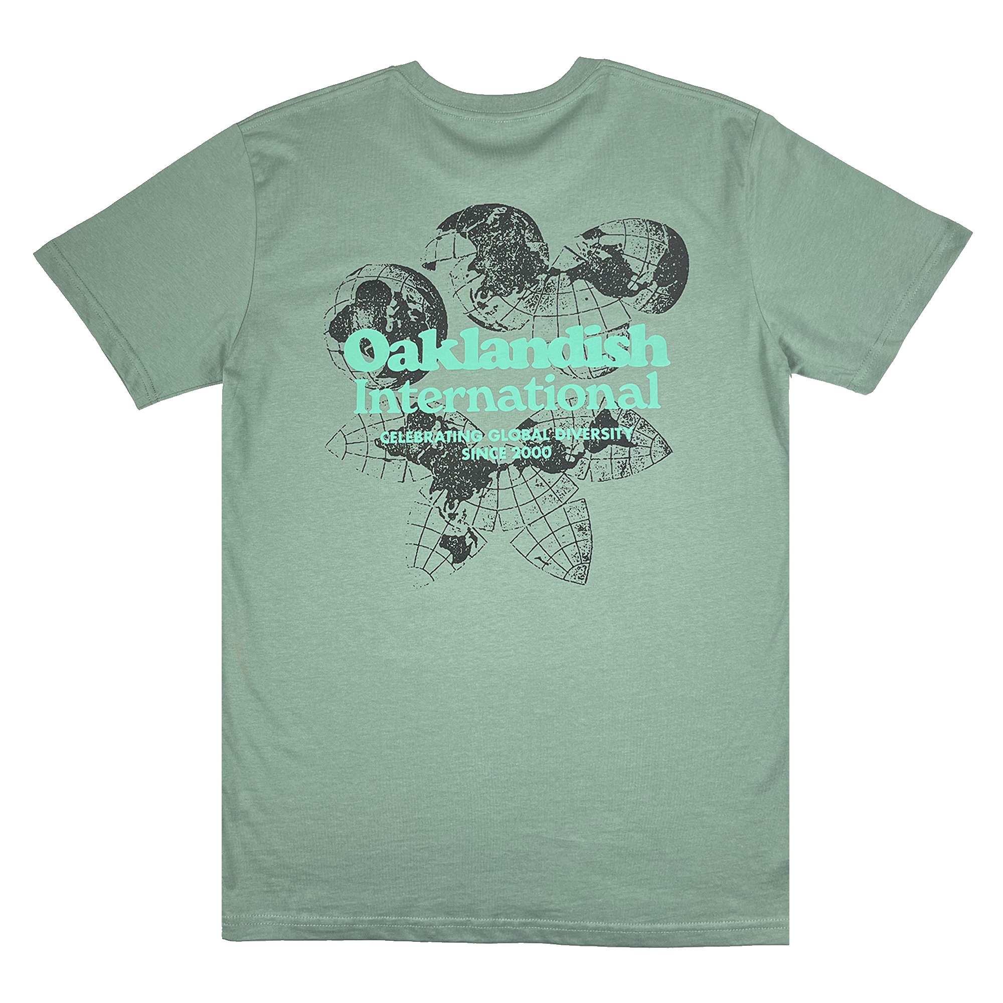 Backside of a sage green t-shirt featuring a green and yellow Oakland International graphic with a caption celebrating global diversity since 2000.