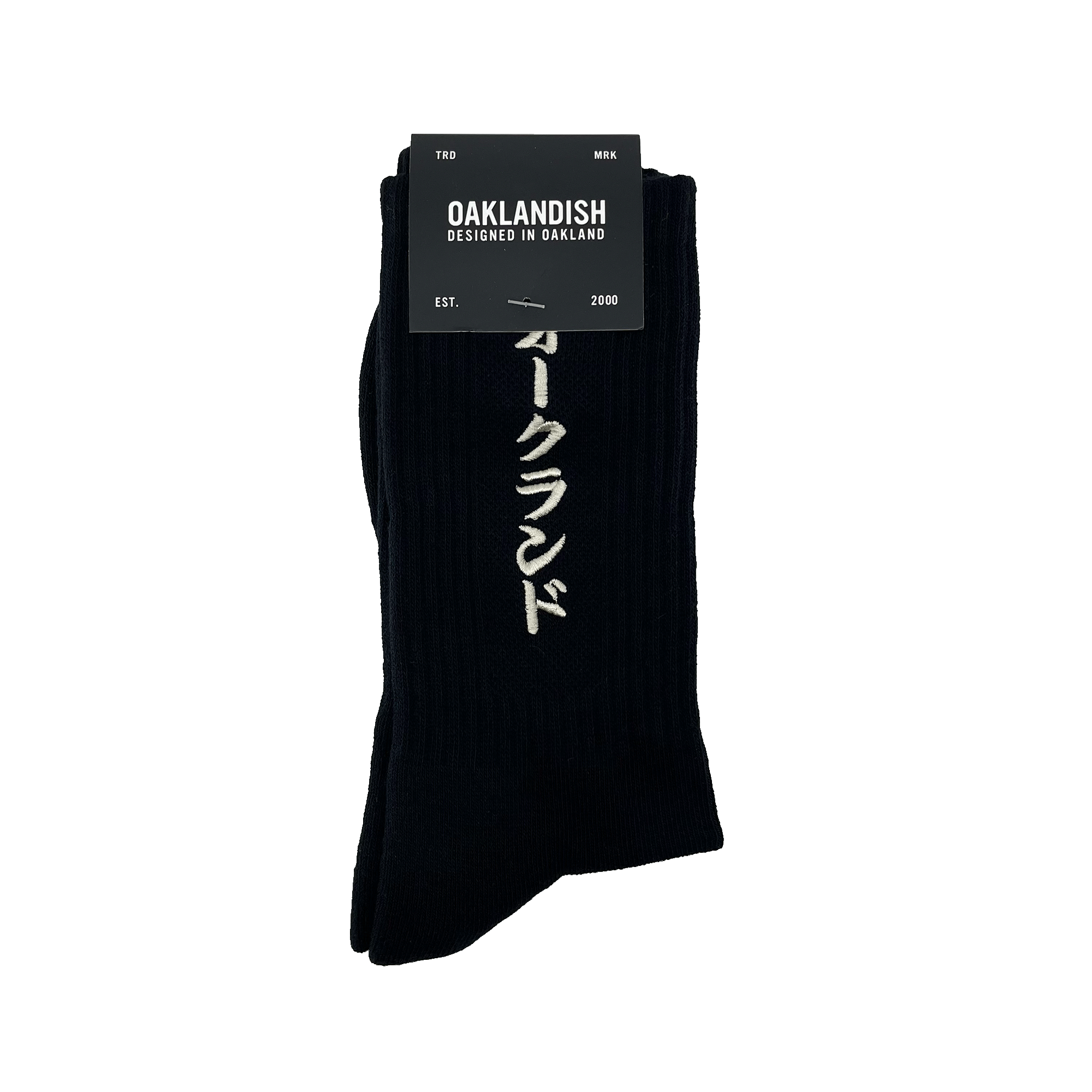 Pair folded black crew socks in Oaklandish packaging with a white embroidered Kanji Japanese script wordmark on the sock.