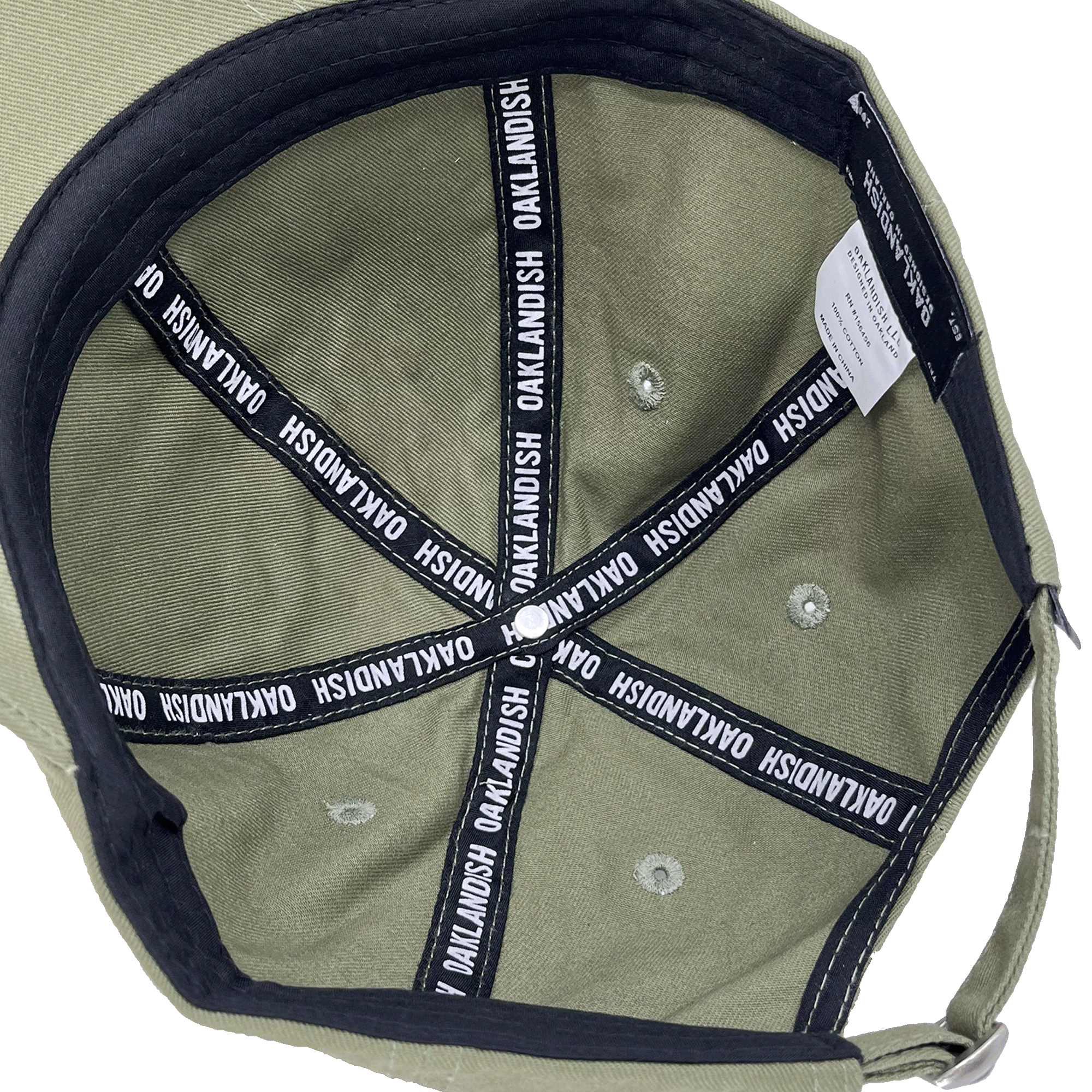 Inside crown view of the black striping inside an army green dad cap with a white Oaklandish wordmark on repeat.