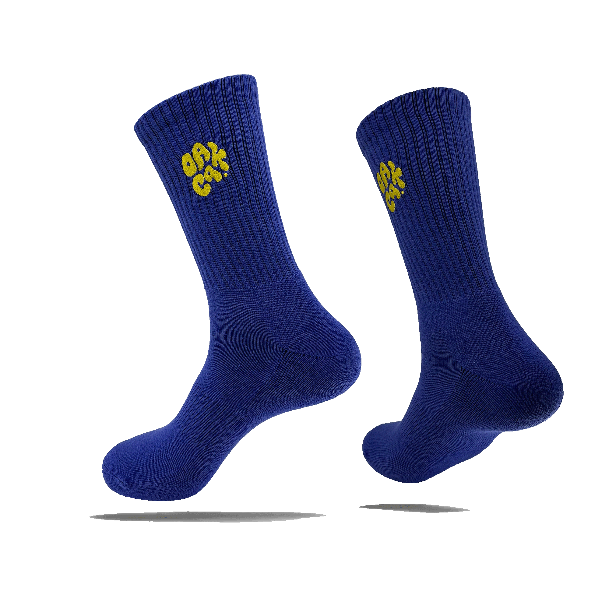 Side view of a pair of blue crew socks with a yellow embroidered OAK CA blob-style wordmark on the side calves.