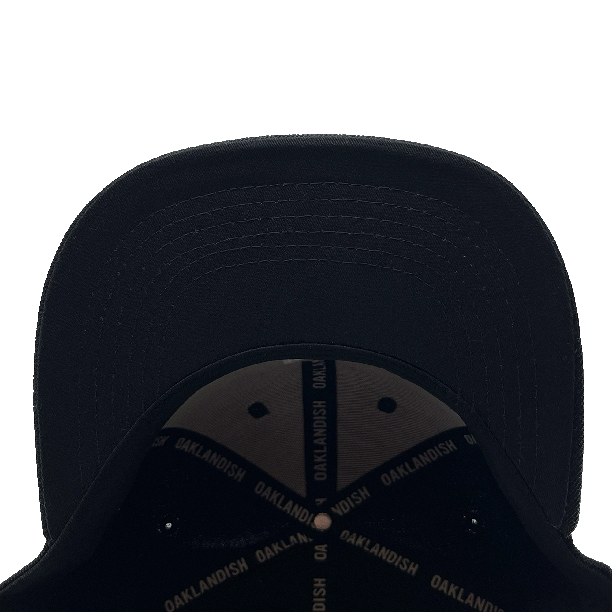 View of the underside of the bill of a black cap with black striping with Oaklandish wordmark on repeat inside the crown.