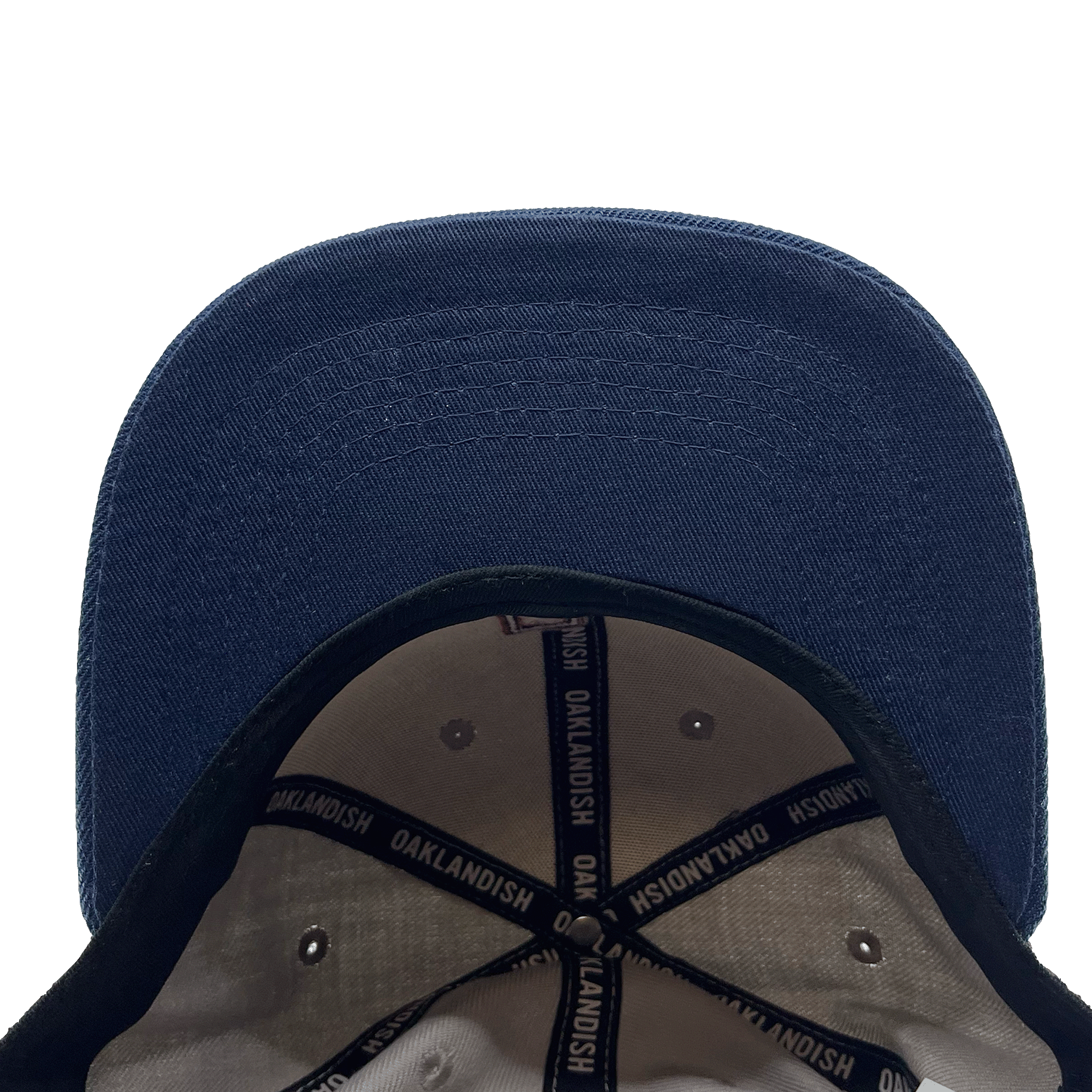 View of the underside of the bill of a navy cap with black striping and Oaklandish wordmark on repeat inside the crown.