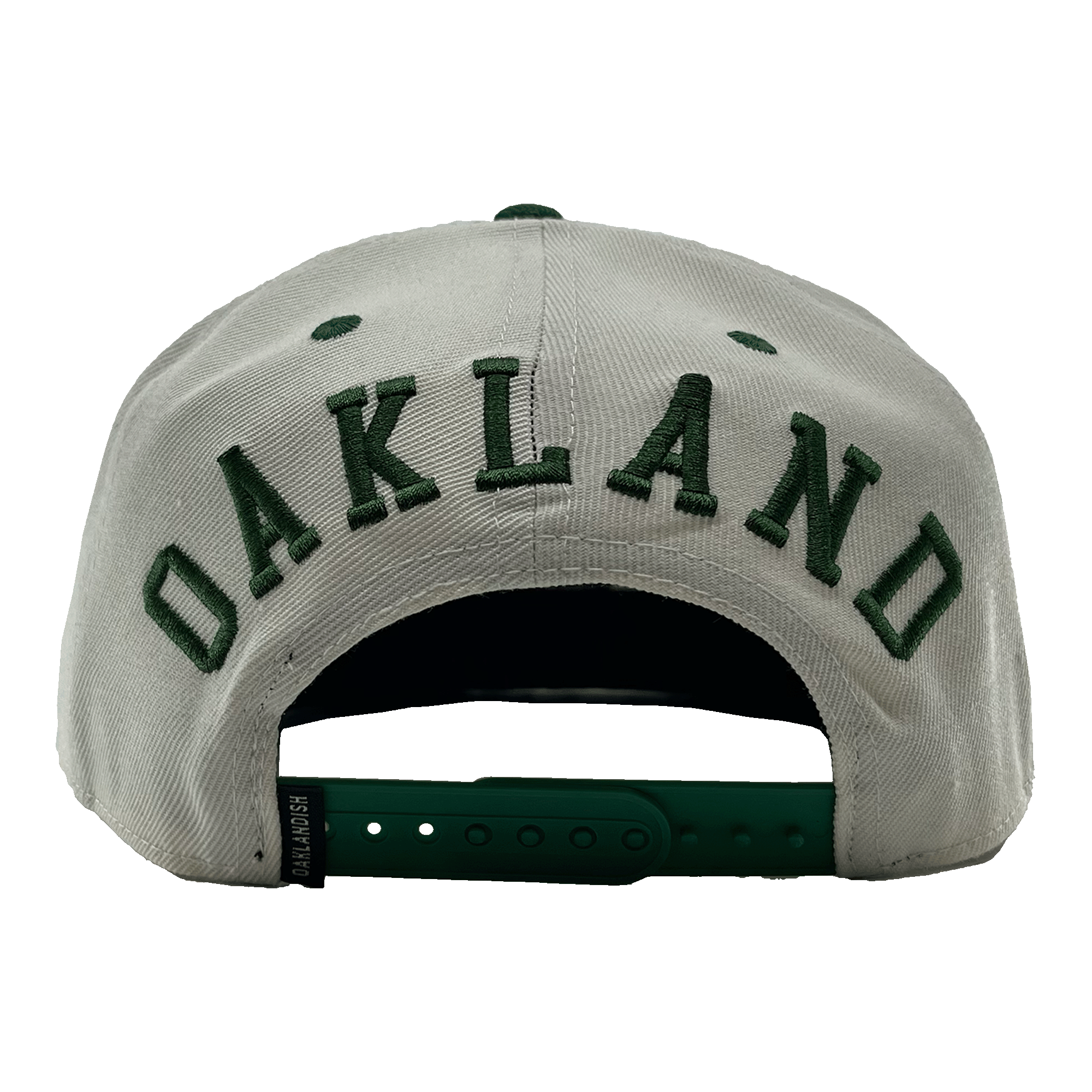 Back view of a white hat with a green adjustable snapback closure, large green embroidered OAKLANDISH wordmark, and small Oaklandish tag. 