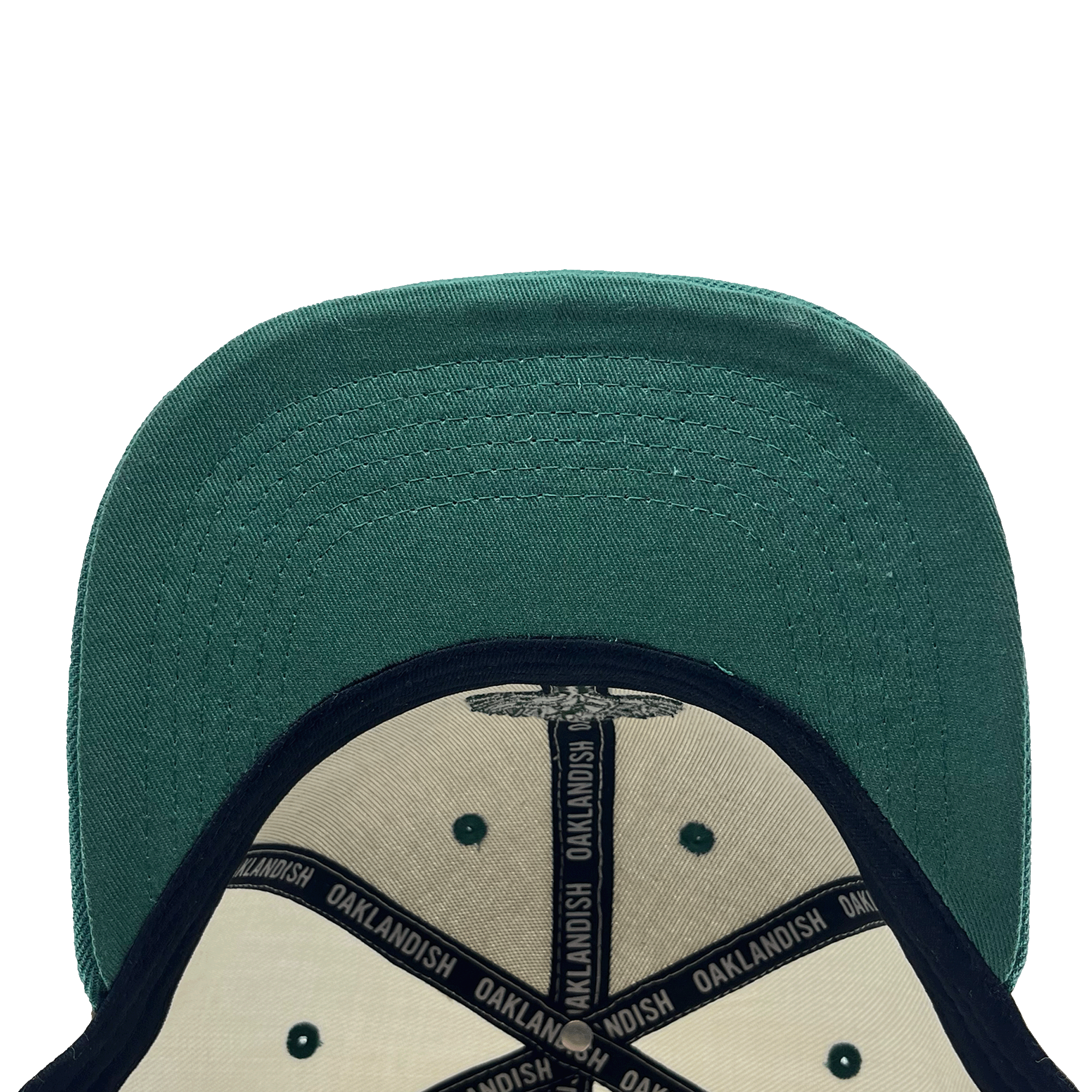 View of the underside of the green bill on a white cap with black striping and Oaklandish wordmark on repeat inside the crown.