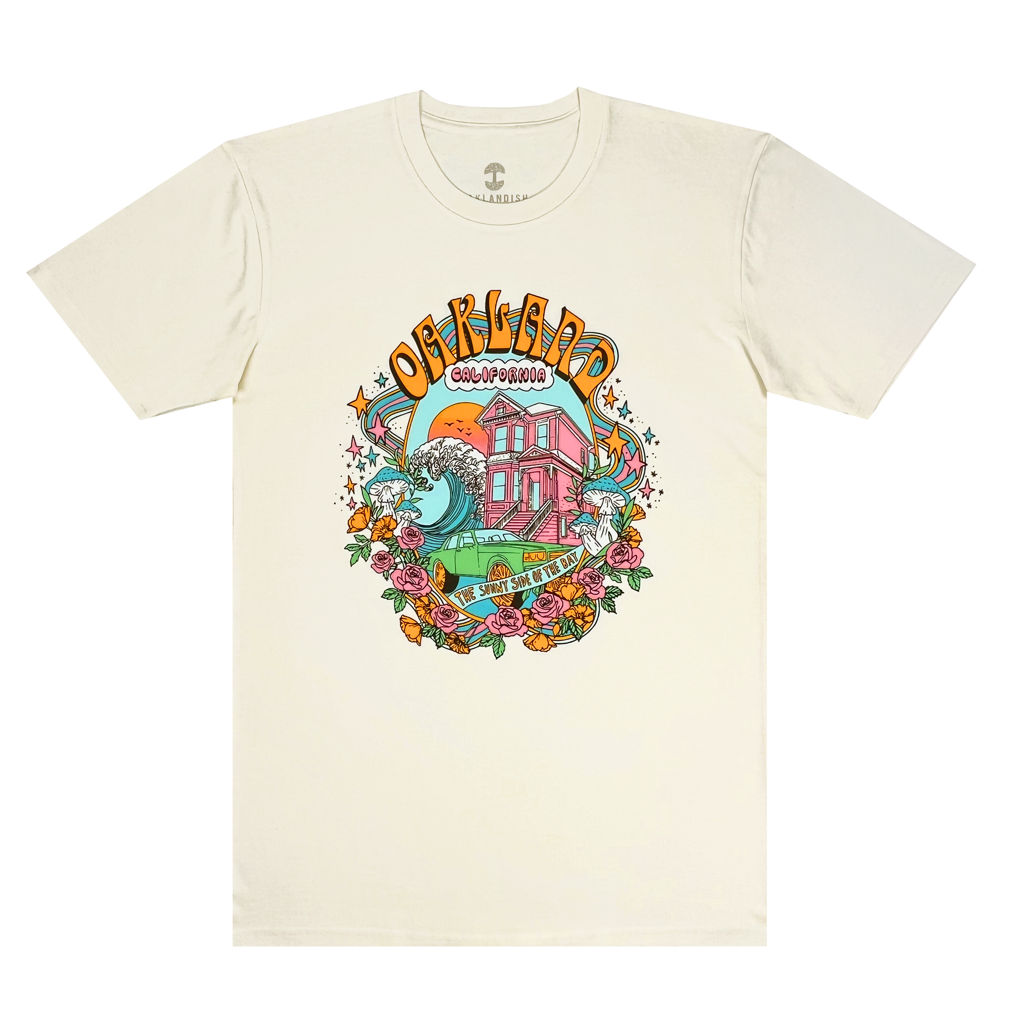 The Oakland Dream Tee by Oaklandish is a white, 100% cotton T-shirt showcasing vibrant 60s-style art. It features a pink house with sunflowers, surrounded by a large wave and colorful flowers. The text "Overboard" and "Colorado" appears above the house, with additional text below it. The retro font and swirling design create a psychedelic feel, while the classic fit makes it perfect for men.