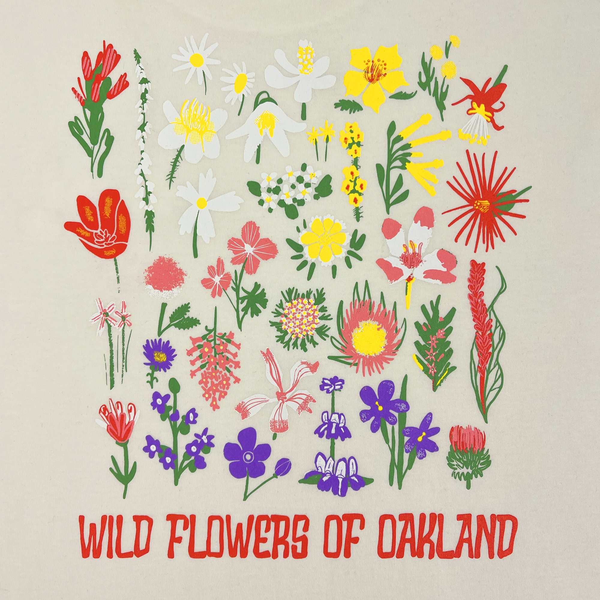 Close-up of graphic depicting various flowers captioned WILD FLOWERS OF OAKLAND on the backside of a natural cotton-color t-shirt.