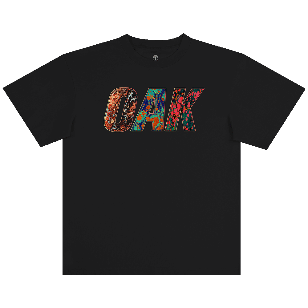 The Oaklandish Oil and Water Tee is a men’s black, heavy-weight cotton t-shirt featuring bold “OAK” lettering filled with vivid abstract patterns that stand out on the plain background.