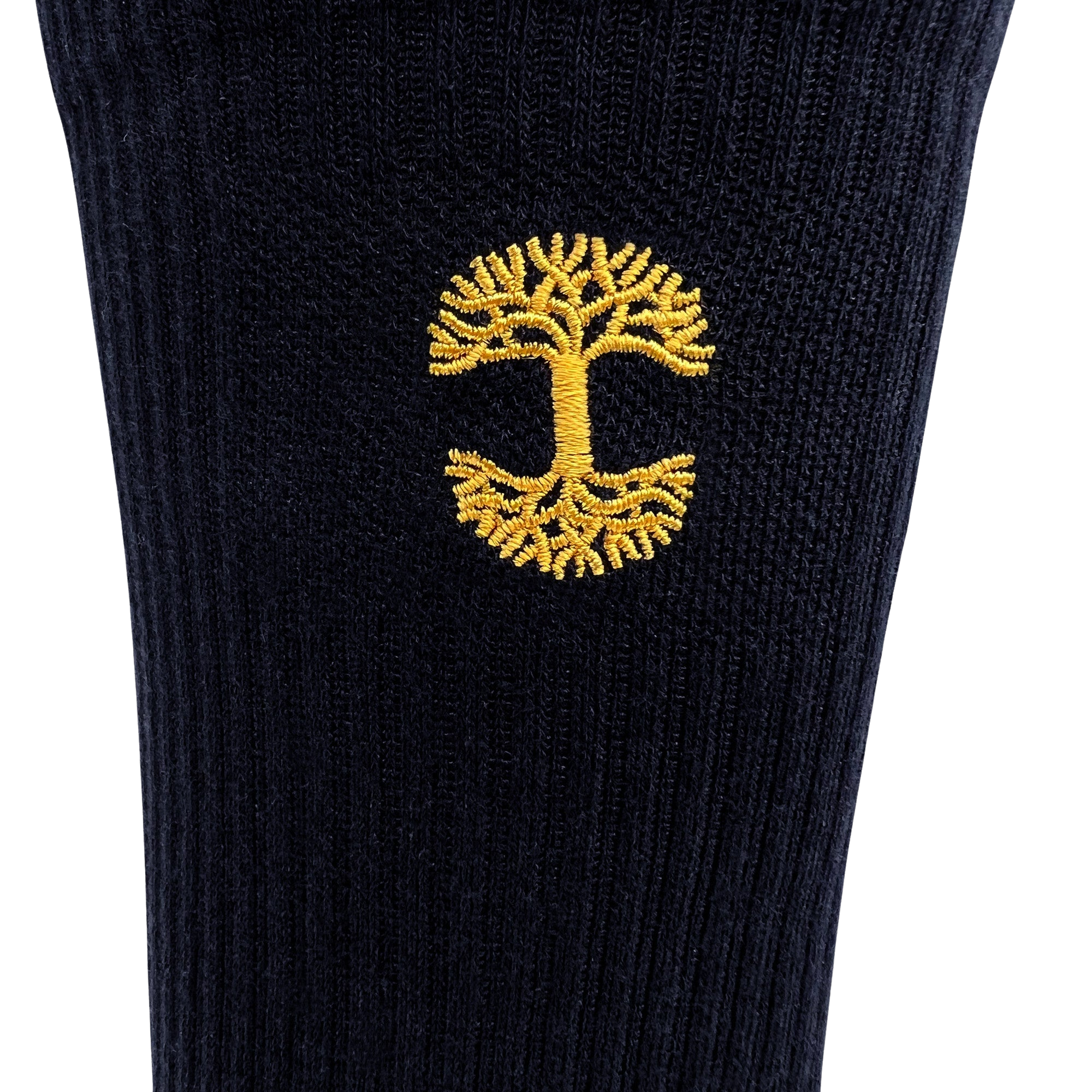 A close-up of the Embroidered Logo Sock by Oaklandish, featuring black and gold ribbed fabric and an intricate yellow tree with detailed roots and branches. The symmetrical design is centrally placed, creating a striking contrast against the dark background.