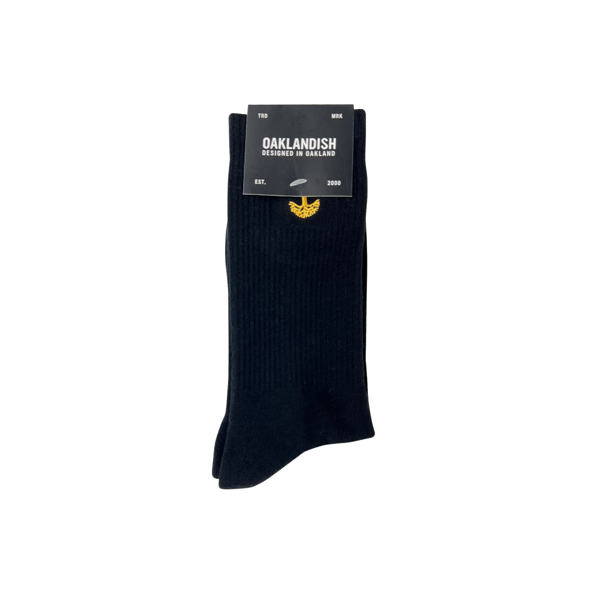 A pair of Oaklandish Embroidered Logo Socks in black/gold, displayed against a white background. The socks feature a small yellow emblem near the top. The packaging reads "OAKLANDISH" and "DESIGNED IN OAKLAND" in white text, along with "EST. 2000" and "MIX." Available in adult sizes.