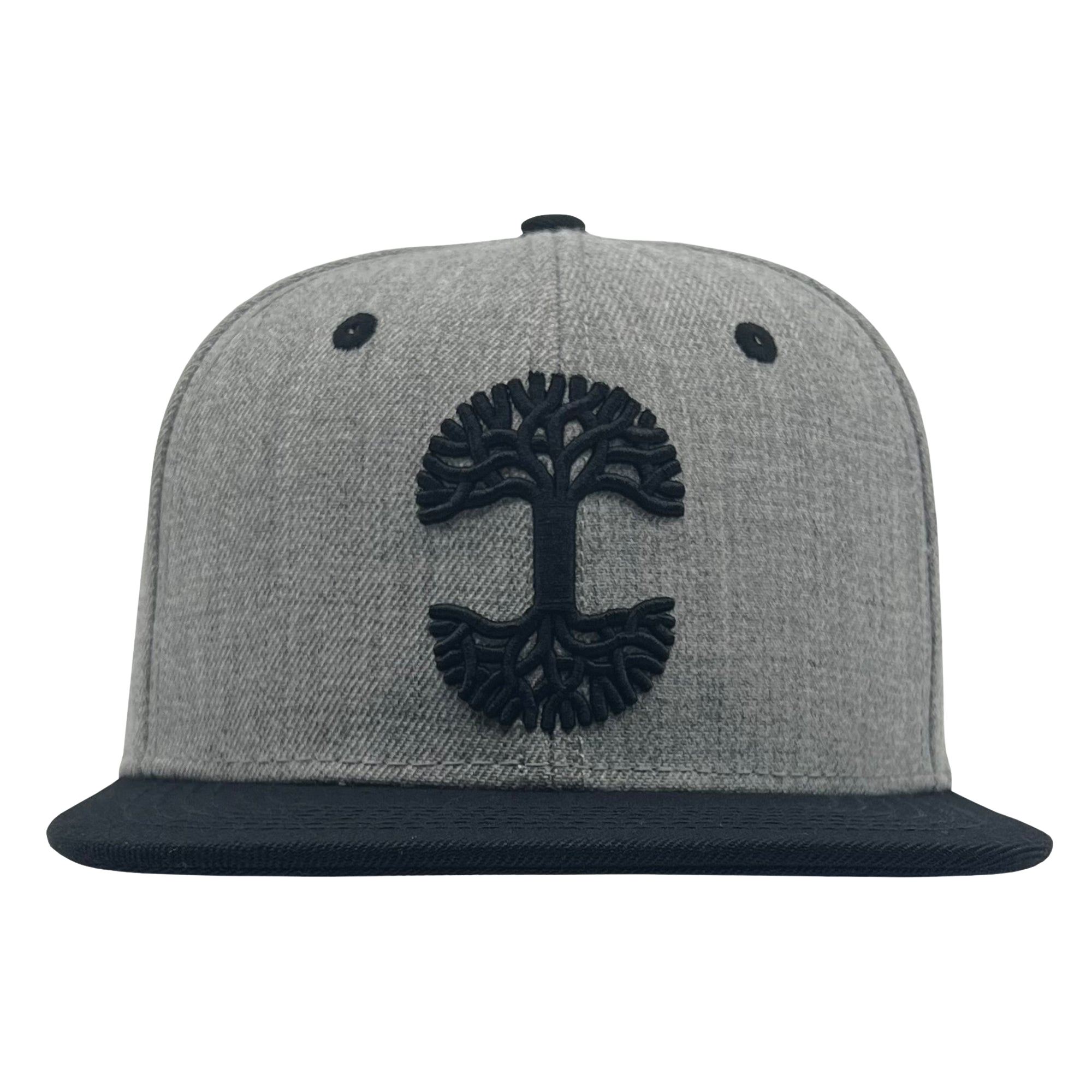 The Oaklandish Classic Snapback by Oaklandish features a flat black brim and a black embroidered tree logo on the front. The hat includes two small black air vents on either side of the logo and a round button on top, all set against a plain white background.