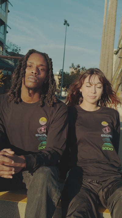 Male and female models wearing the black ls Futuristic tee. seated, then look up and down and are wearing Lager tees.