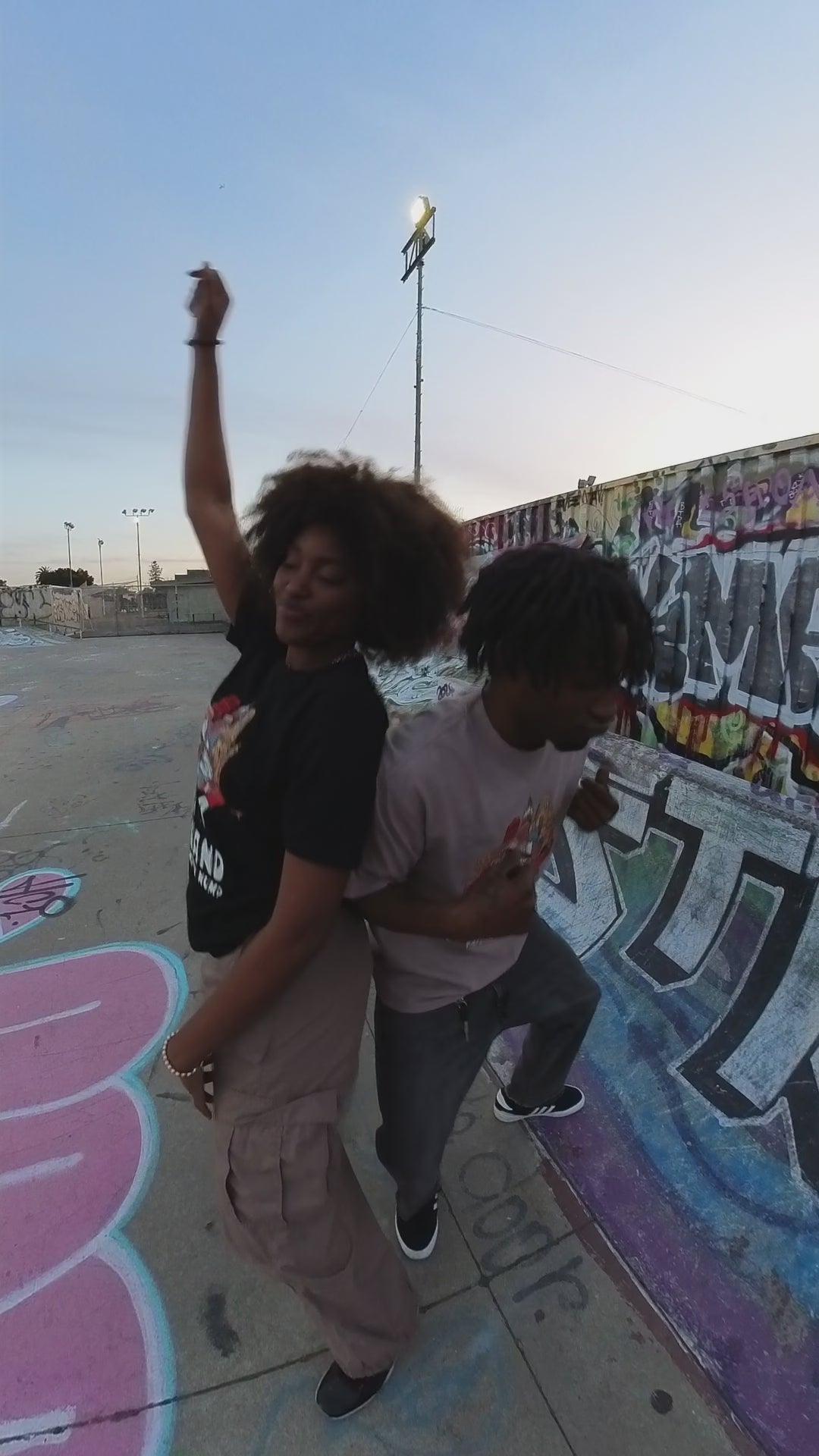 Models dancing in the skate park wearing the Digital Underground tees.