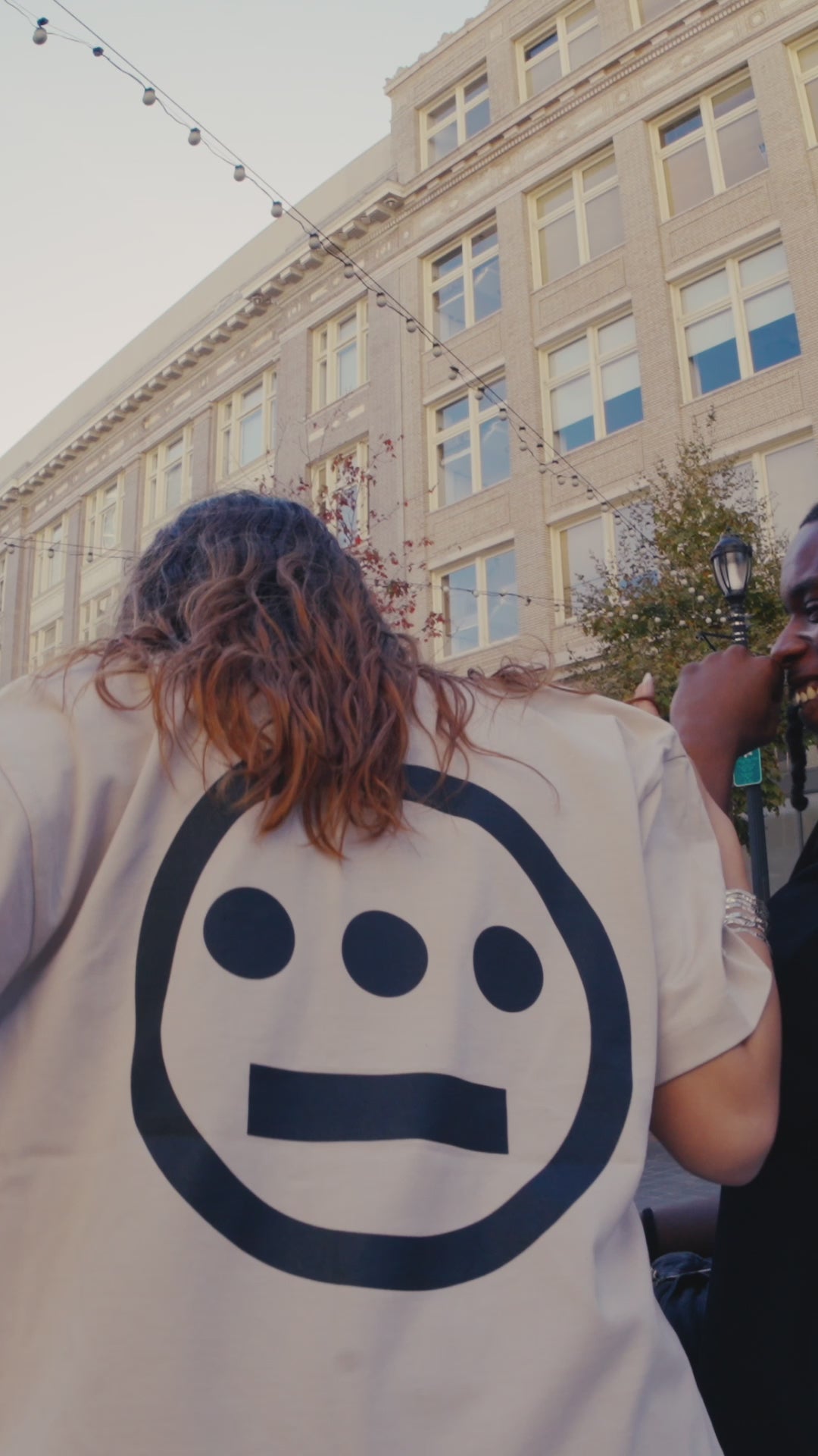 Models in Downtown Oakland, happy and smiling wearing Oaklandish and Hiero heavyweight baseball jerseys.