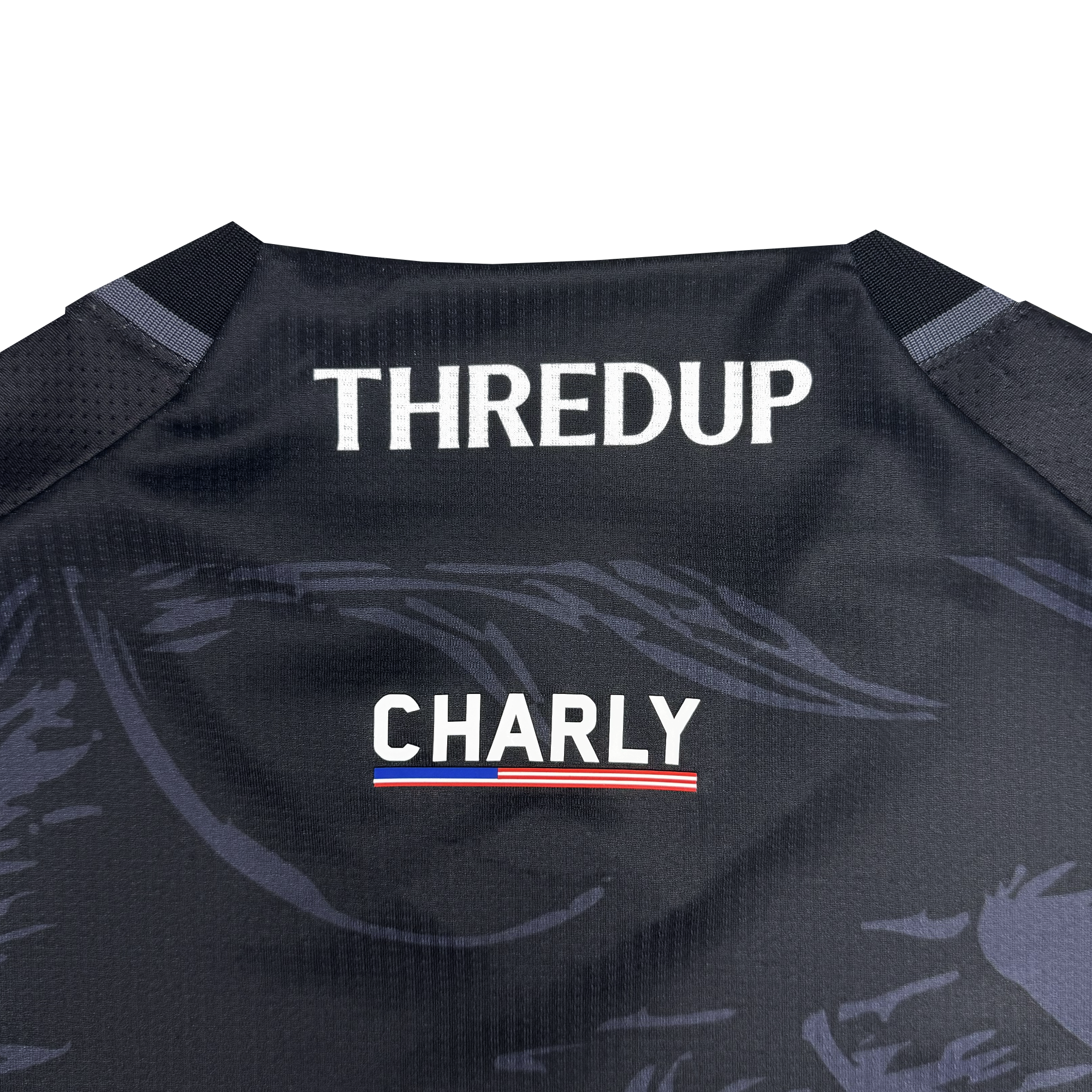 The image displays the back of a black Custom Unisex Oak-ness Awakens Kit by Oakland Roots SC. “THREDUP” appears at the top in bold white letters, with “CHARLY” beneath and a red, white, and blue underline—a tribute to Oakland folklore.
