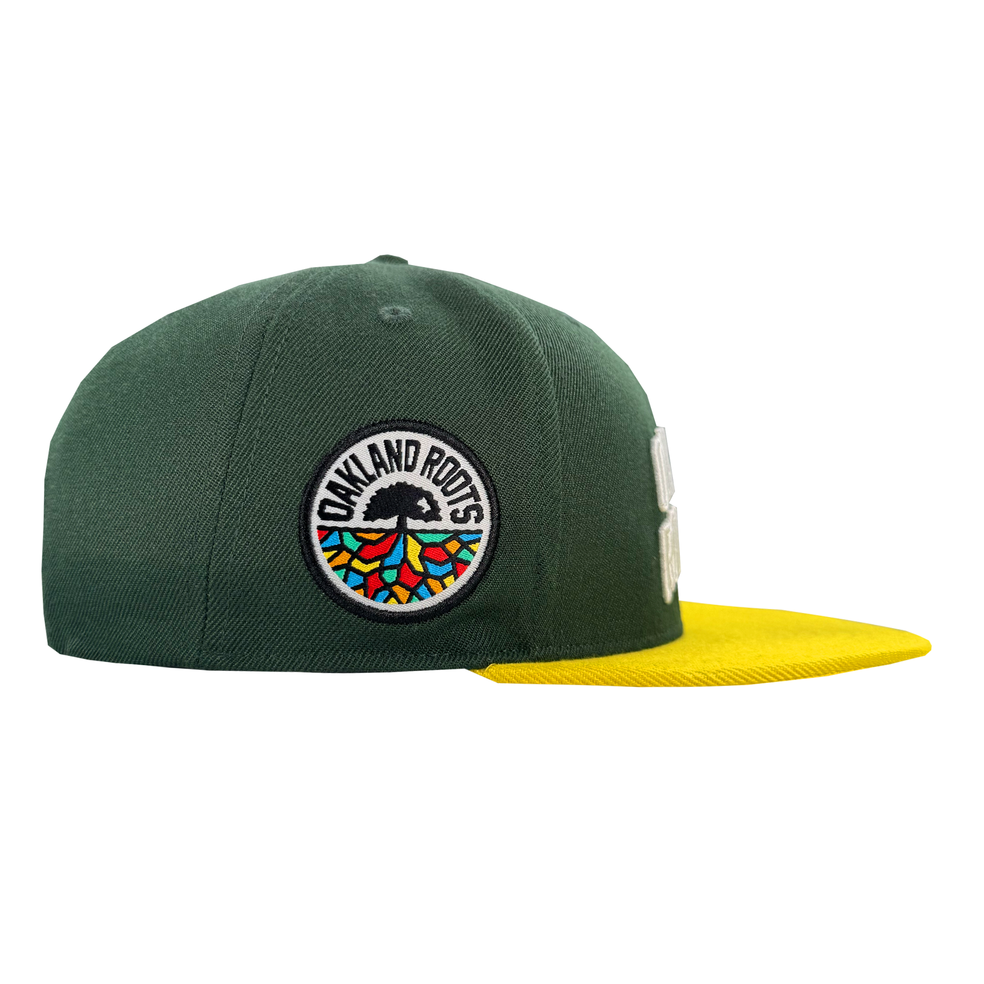 The Oakland Roots SC Arch Text Snapback by Oakland Roots SC features a green crown, flat bright yellow brim, and a left-side patch with a black tree and colorful roots—ideal for any Sports Club fan. Background: white.