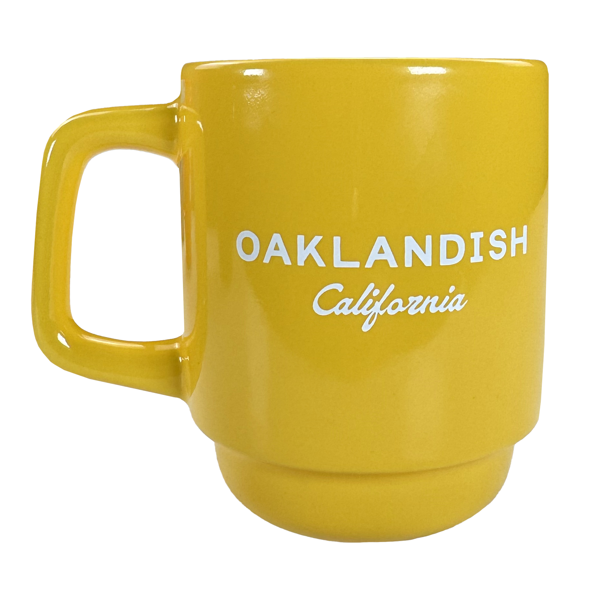 The Logo Stack Mug by Oaklandish is a bright yellow ceramic mug with a large handle. "OAKLANDISH" in bold white uppercase letters and "California" in small cursive are printed on the front. Background is plain white.