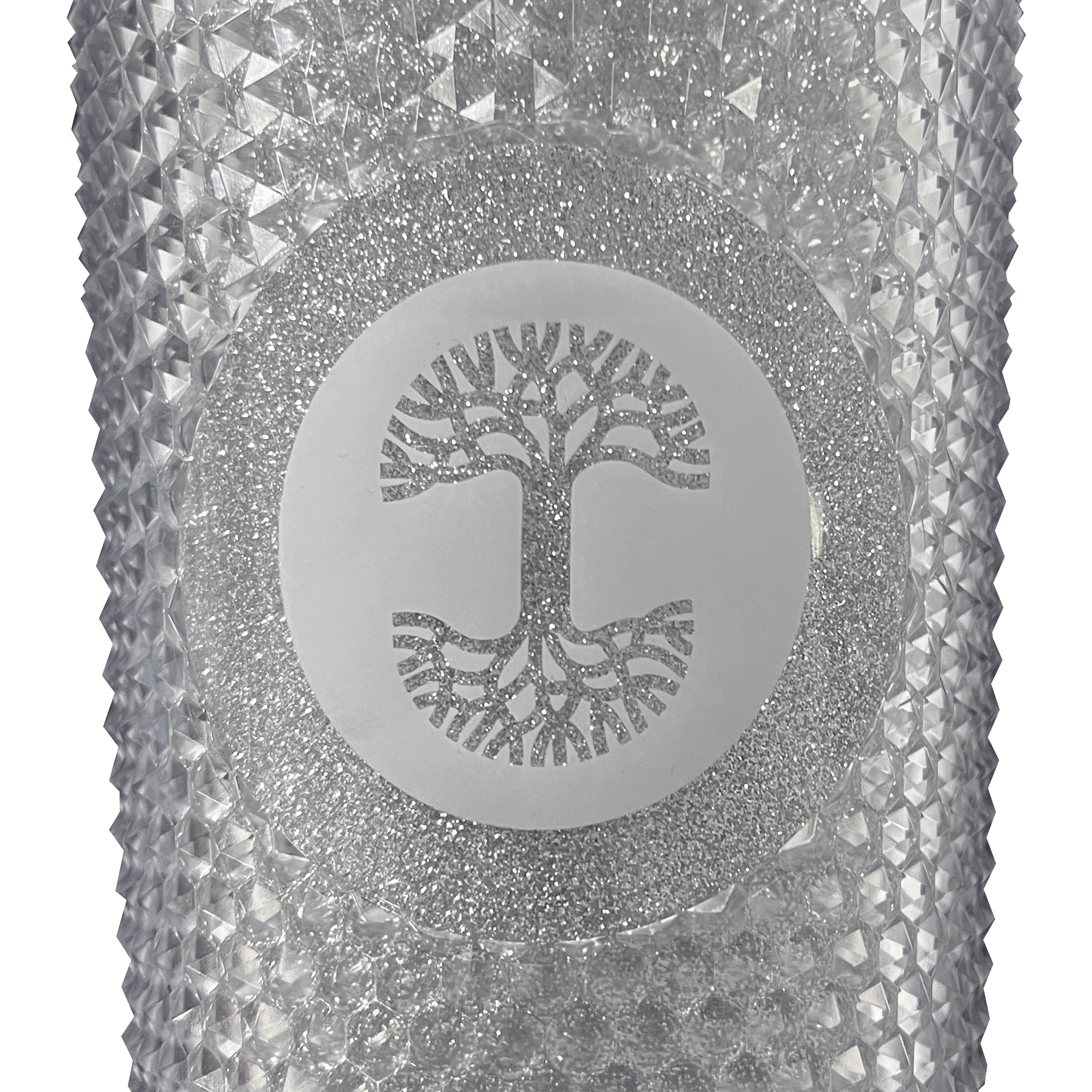 A detailed close-up of the Oaklandish tree logo is sparkly silver on front of a silver-studded bling travel tumbler. 